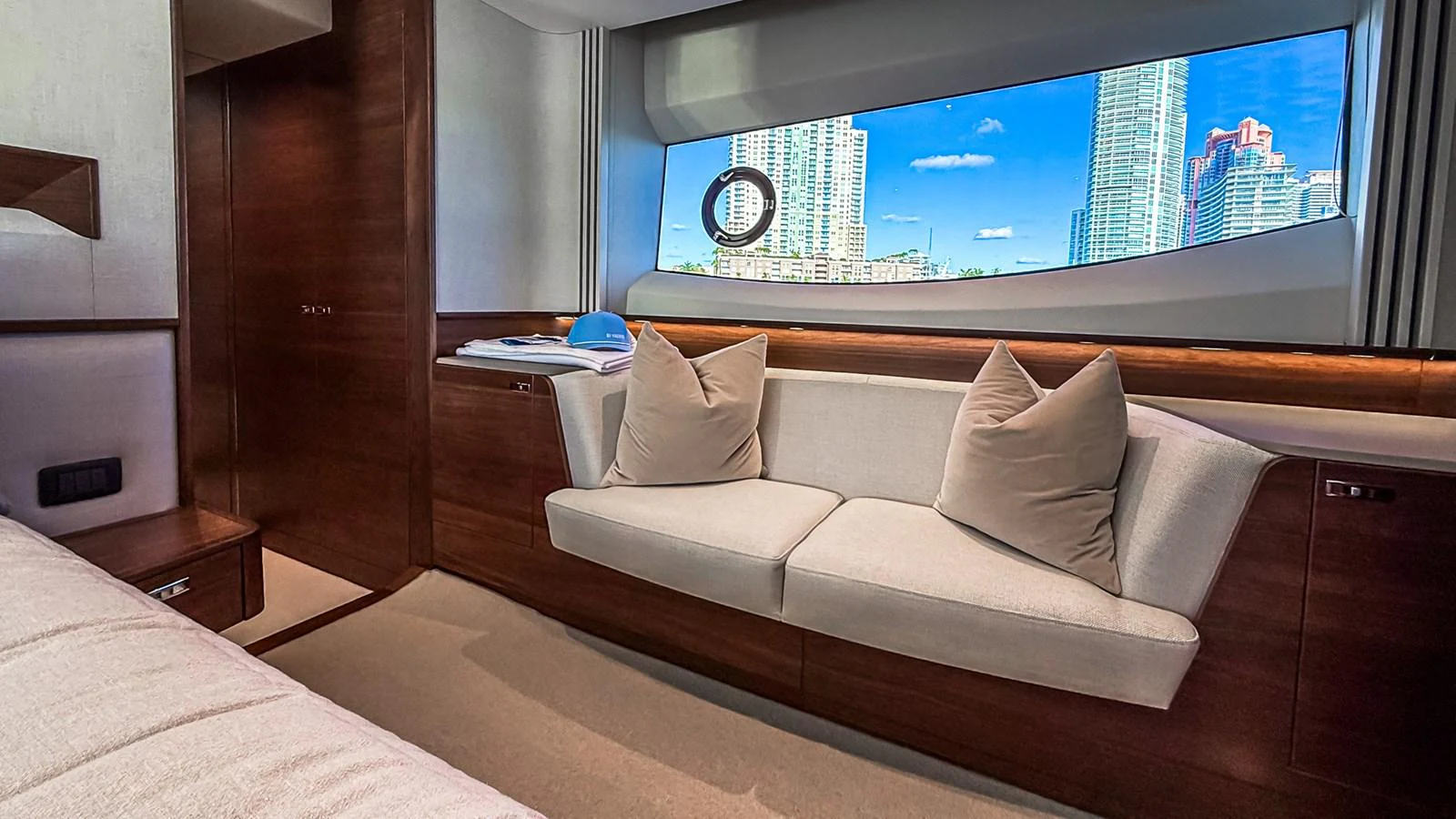 A cozy interior lounge area with a large window offering a cityscape view. aboard NAUTILUS Yacht for Sale
