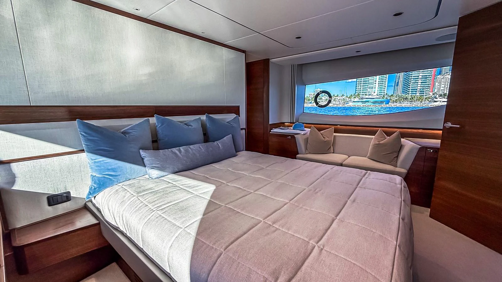 A luxurious stateroom with a large bed and a scenic view through the window. aboard NAUTILUS Yacht for Sale