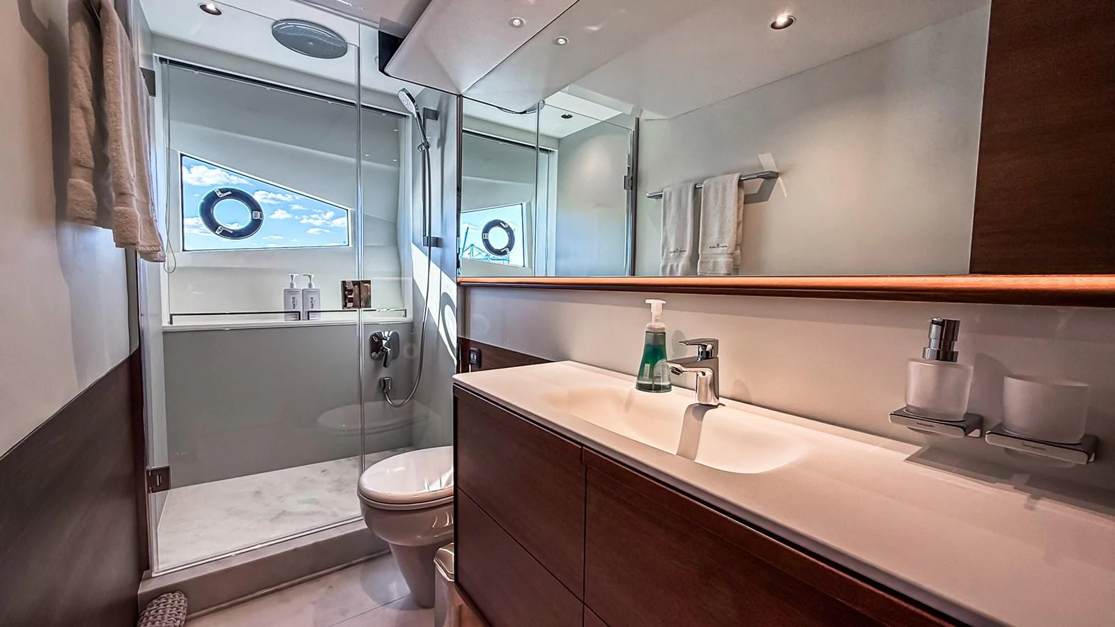 A sleek and modern yacht bathroom with a glass-enclosed shower and stylish fixtures. aboard NAUTILUS Yacht for Sale