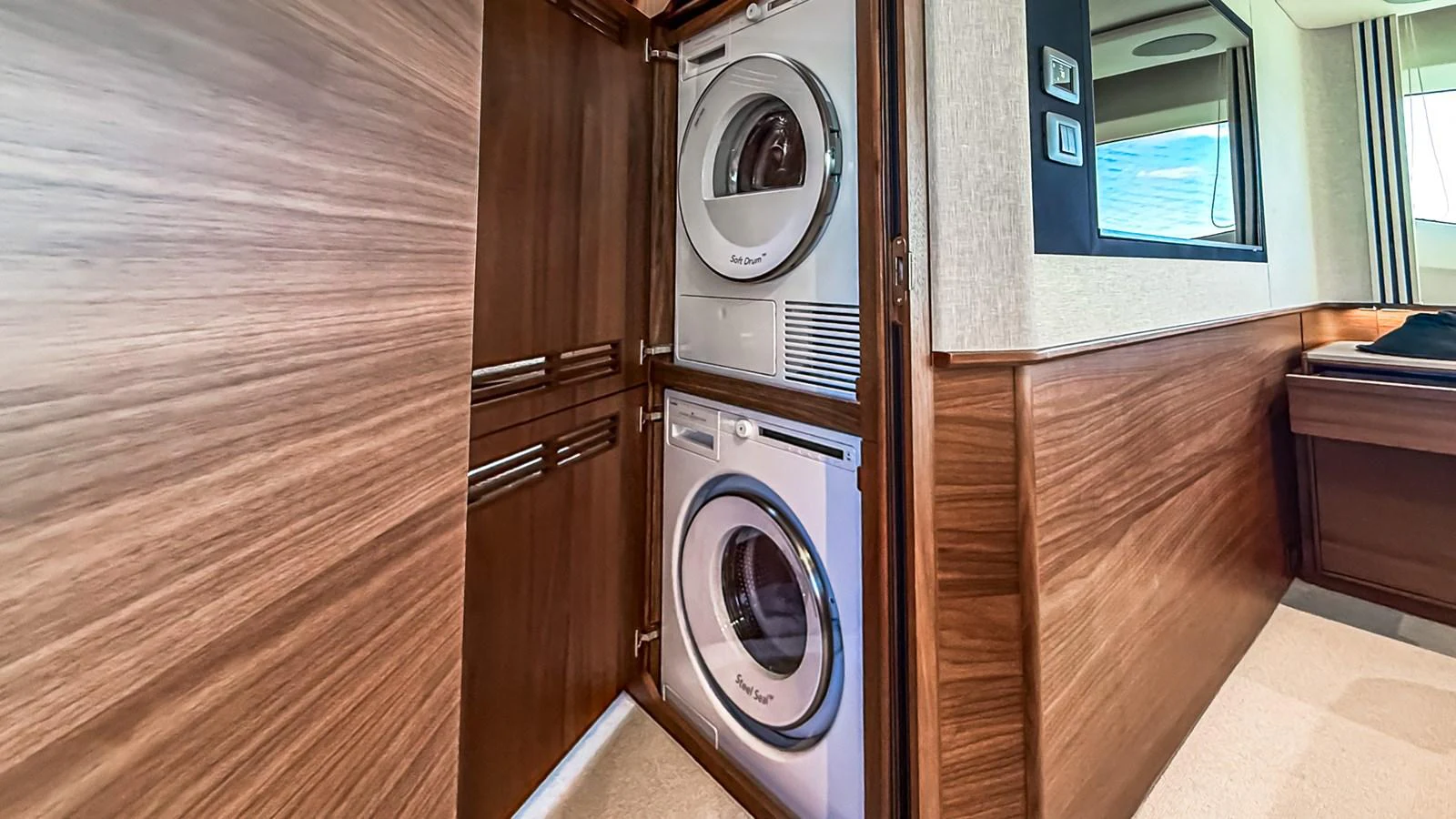 The yacht features a convenient laundry area with a stacked washer and dryer. aboard NAUTILUS Yacht for Sale