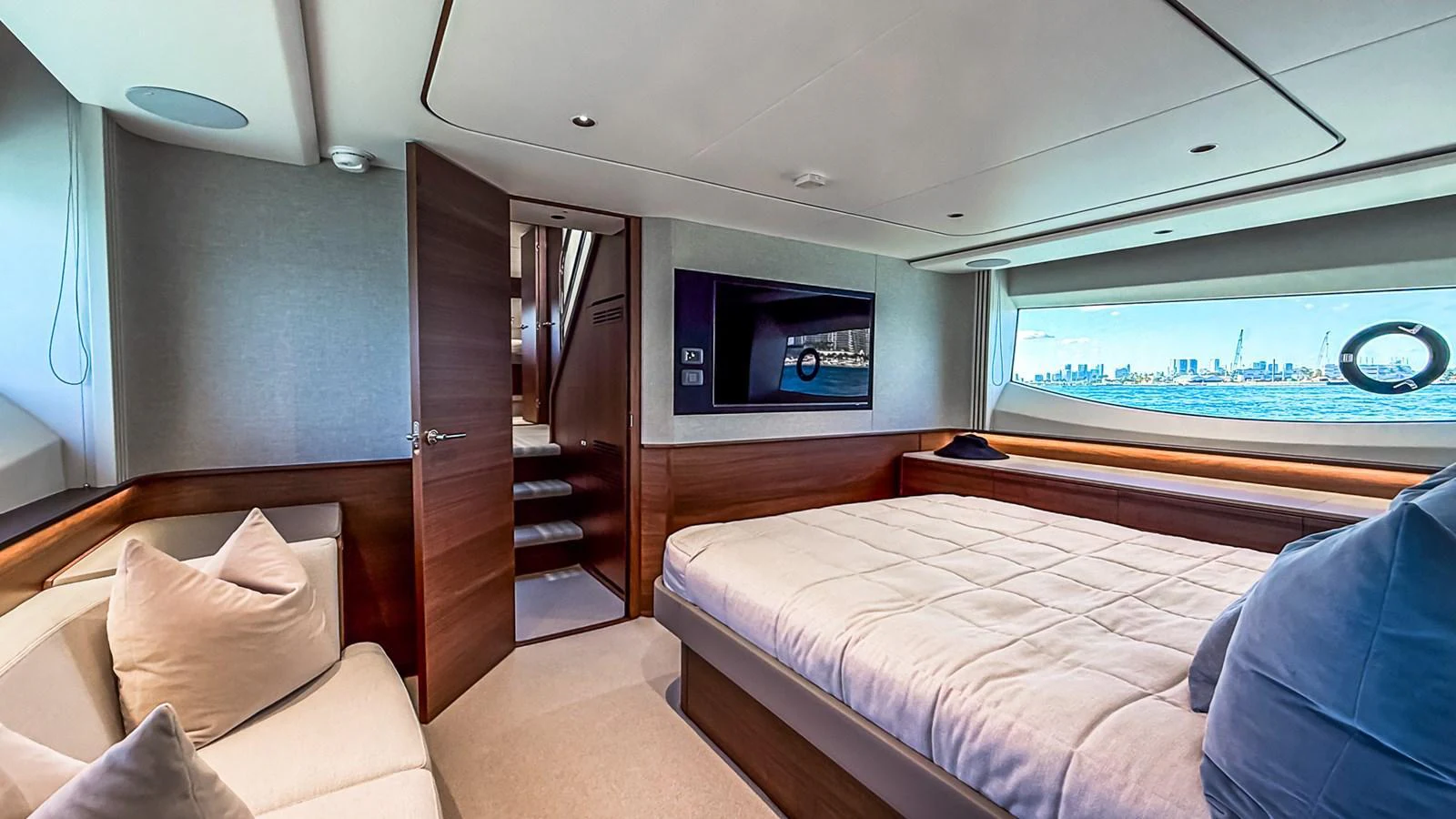 The stateroom features a plush bed, a cozy seating area, and a large window offering stunning views. aboard NAUTILUS Yacht for Sale