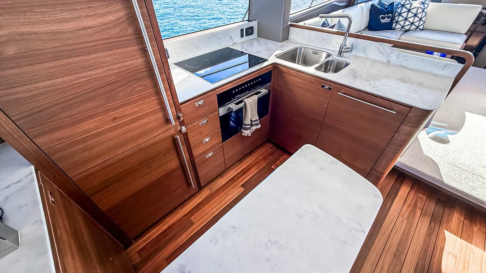 The yacht's galley features sleek wooden cabinetry, a modern stovetop, and a marble countertop, offering a stylish and functional cooking space. aboard NAUTILUS Yacht for Sale