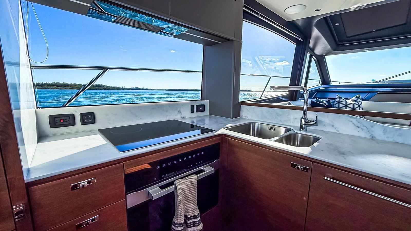 The yacht's galley features modern appliances and a sleek design with a view of the sea. aboard NAUTILUS Yacht for Sale