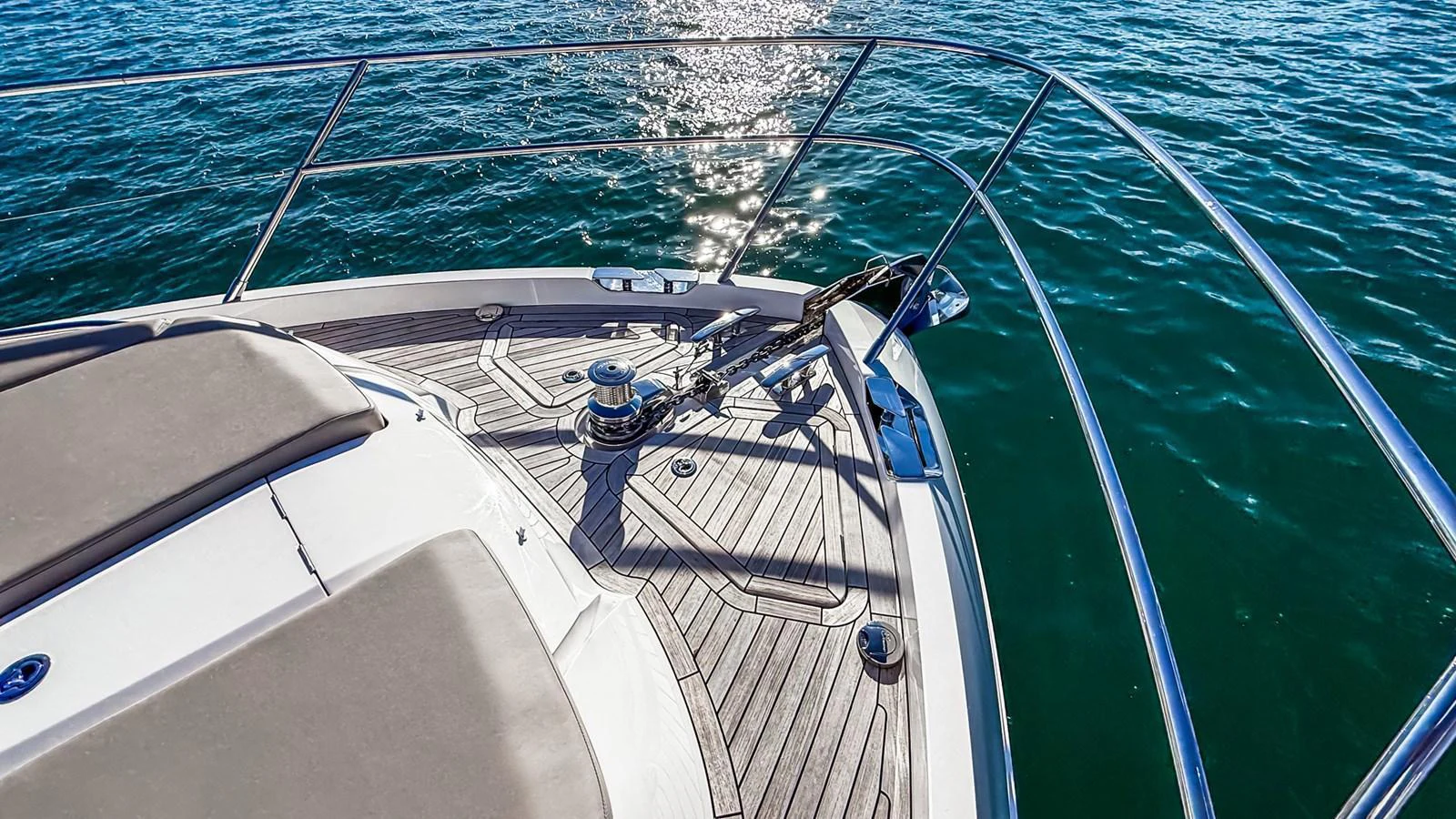 The bow of the yacht features a sleek deck with polished railings and a sunlit view of the water. aboard NAUTILUS Yacht for Sale