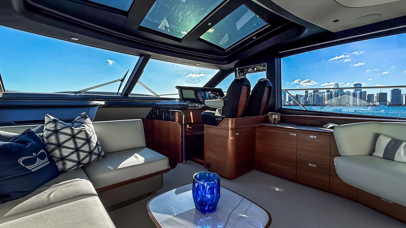 The yacht's salon offers a luxurious and spacious seating area with panoramic views of the city skyline. aboard NAUTILUS Yacht for Sale