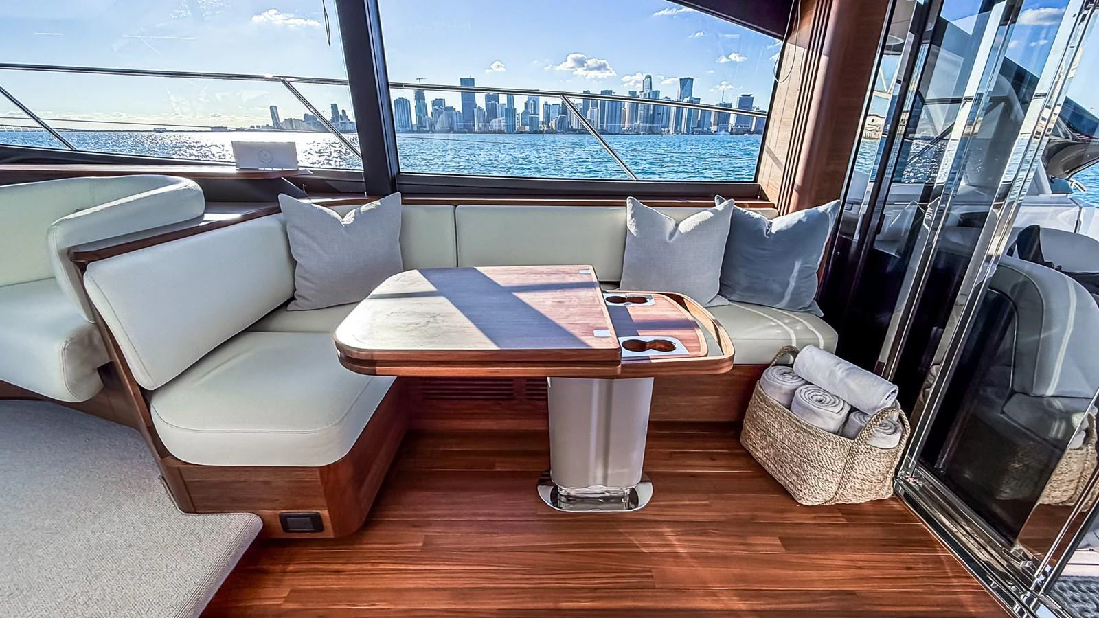 The saloon offers a comfortable seating area with a stunning view of the city skyline through large windows. aboard NAUTILUS Yacht for Sale