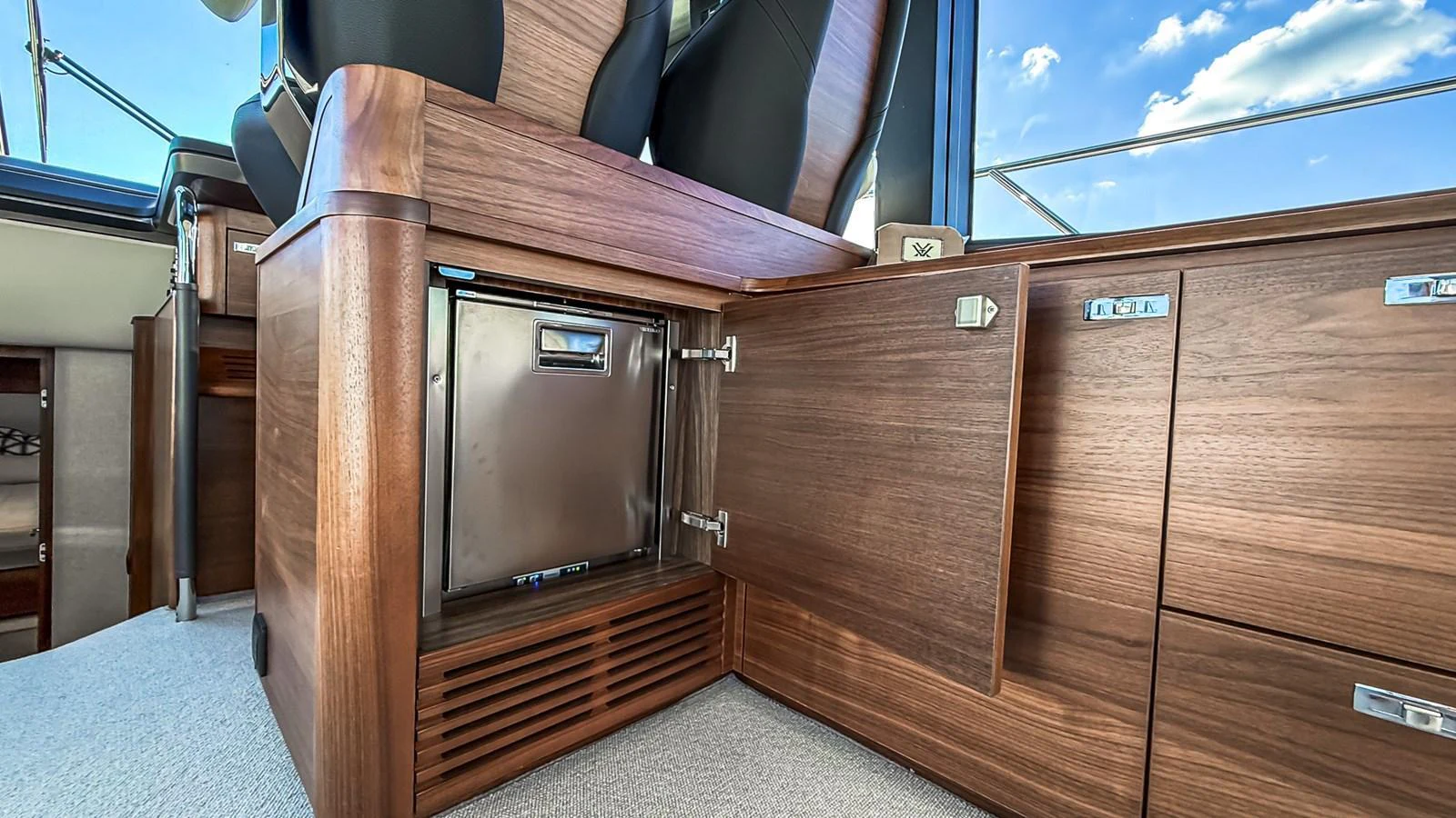 A close-up view of the yacht's wooden cabinetry and built-in refrigerator. aboard NAUTILUS Yacht for Sale