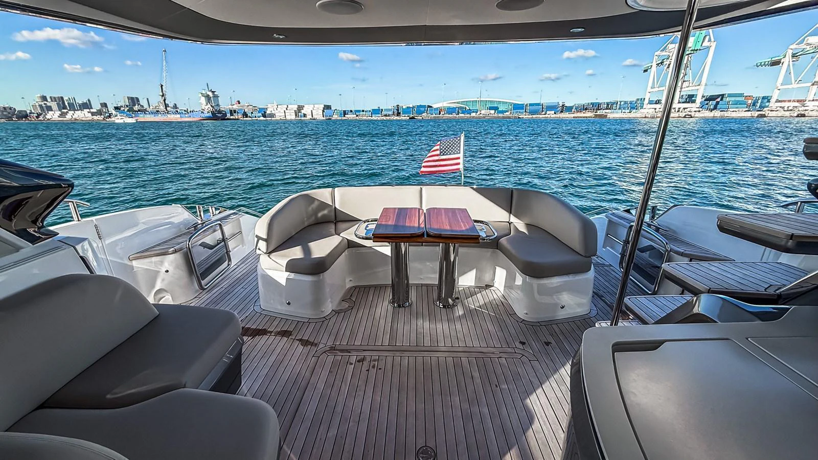 The aft deck offers a spacious seating area with a table, perfect for enjoying the view of the harbor. aboard NAUTILUS Yacht for Sale