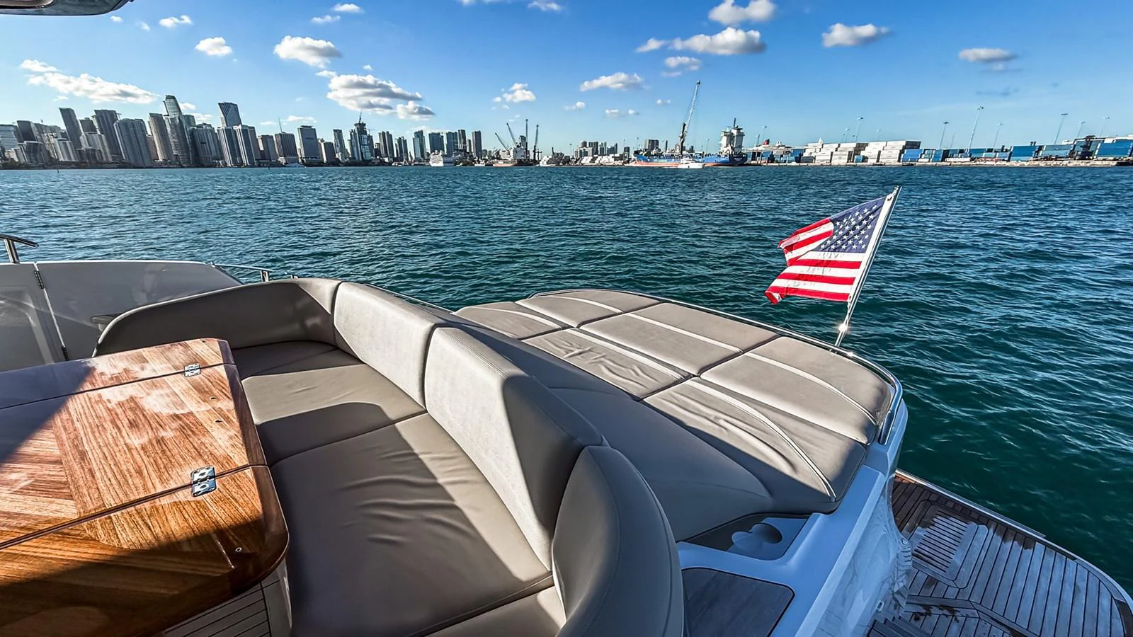 The yacht's aft deck offers a spacious lounging area with a stunning view of the city skyline. aboard NAUTILUS Yacht for Sale