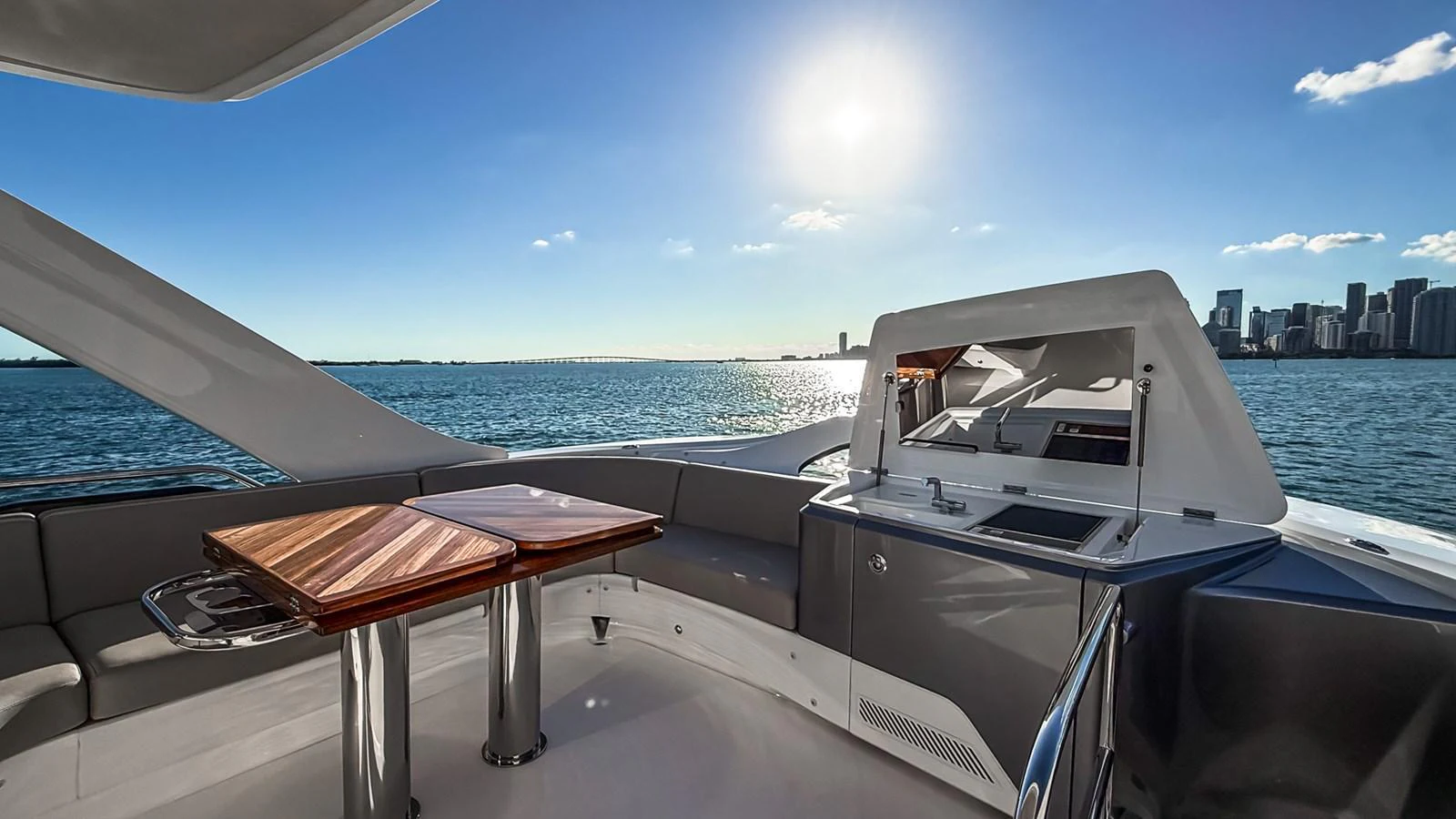 The flybridge offers a luxurious outdoor seating and dining area with stunning views of the water and city skyline. aboard NAUTILUS Yacht for Sale