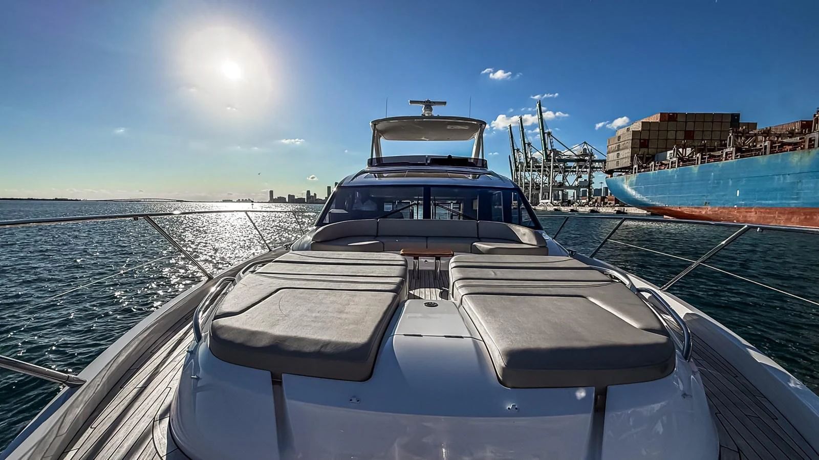 The yacht's foredeck features spacious sun pads under a clear, sunny sky. aboard NAUTILUS Yacht for Sale