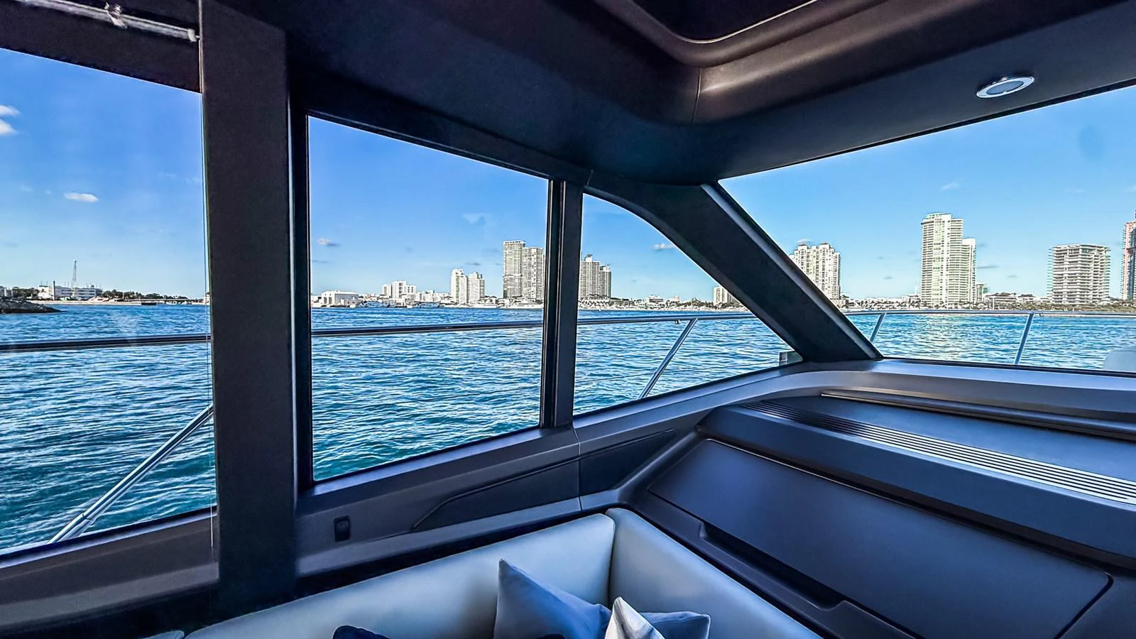 The interior view showcases large windows offering a stunning cityscape and ocean view. aboard NAUTILUS Yacht for Sale