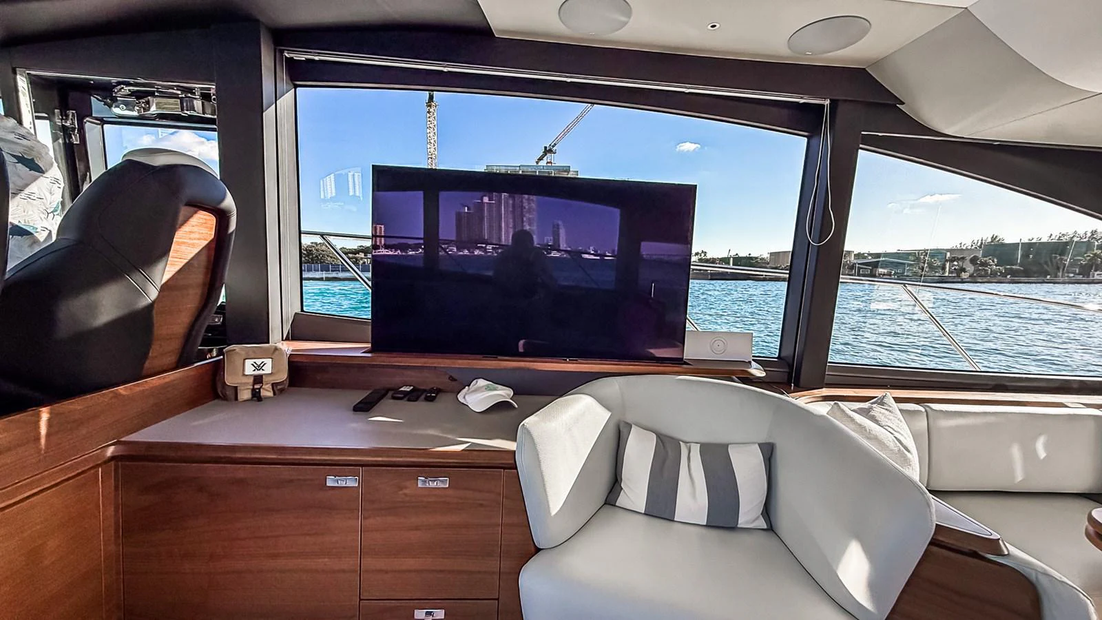 The yacht's salon features a comfortable seating area with a view of the water through large windows. aboard NAUTILUS Yacht for Sale