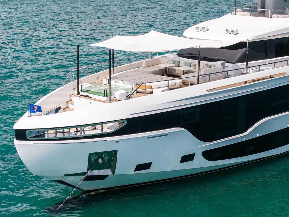 The yacht's aft deck features a spacious lounging area with elegant seating and a sunshade, perfect for relaxation on the water. aboard TYCOON Yacht for Sale