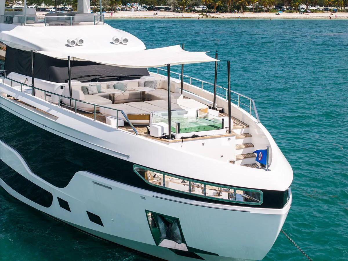 The yacht's foredeck features a spacious lounging area with comfortable seating and a sunshade. aboard TYCOON Yacht for Sale