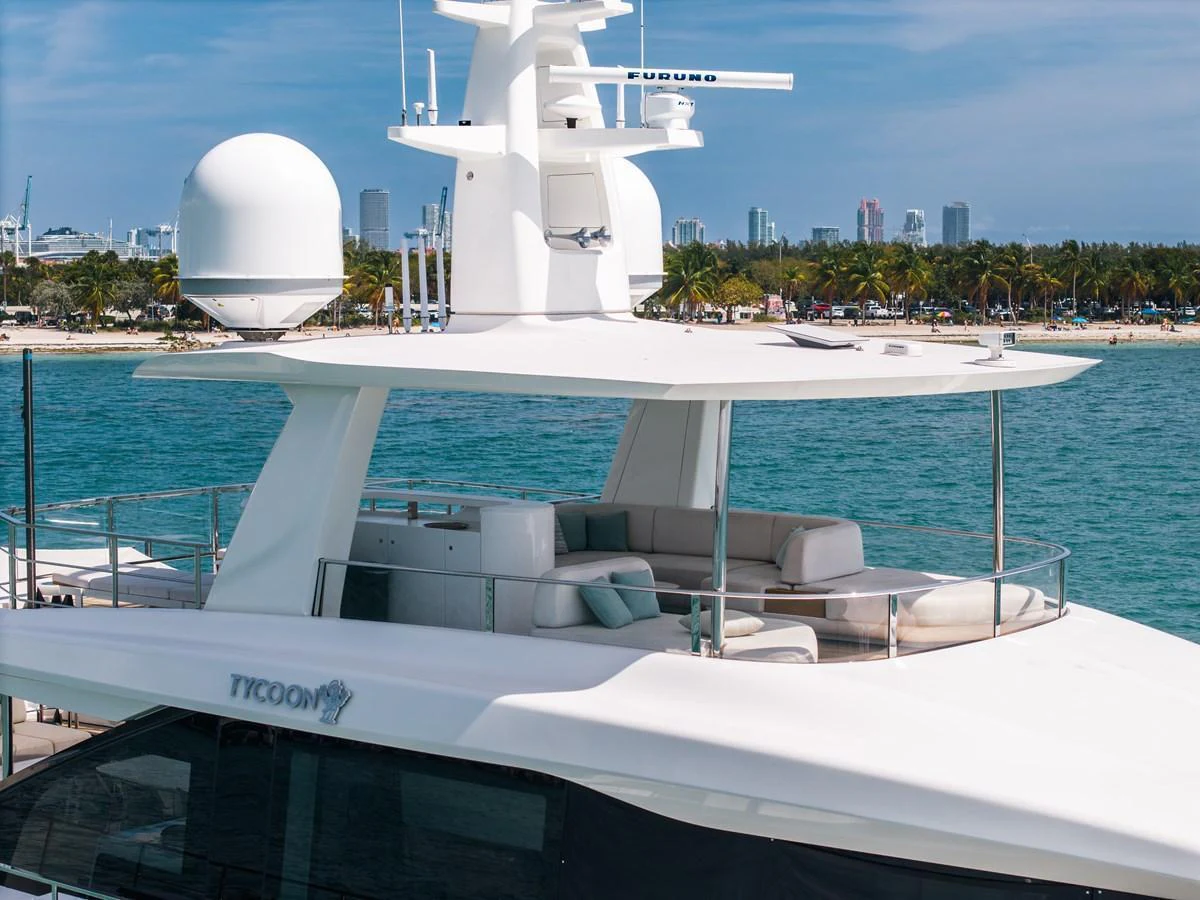 The yacht's flybridge offers a luxurious seating area with stunning views of the surrounding waters and cityscape. aboard TYCOON Yacht for Sale