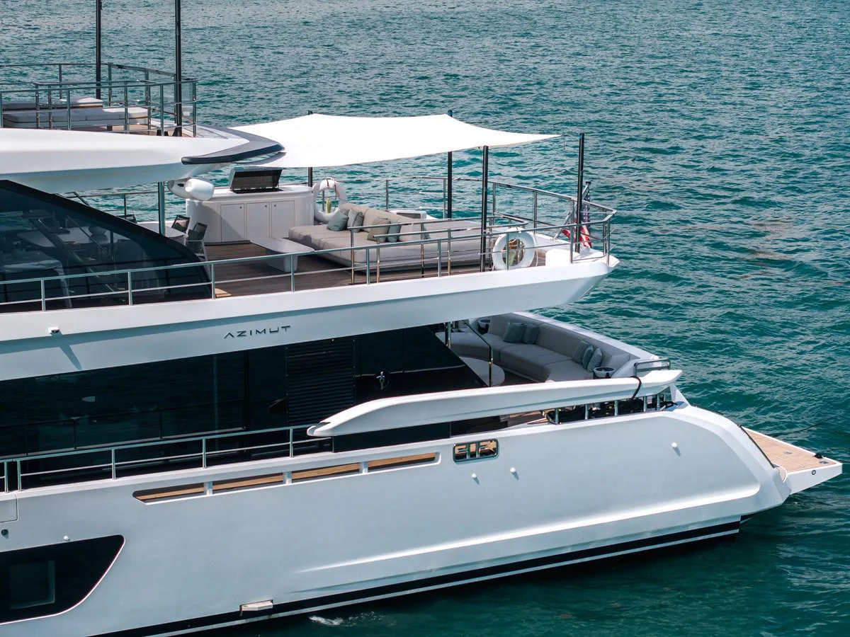 The yacht's sleek exterior showcases a luxurious aft deck with ample seating and a shaded area, perfect for relaxation on the water. aboard TYCOON Yacht for Sale