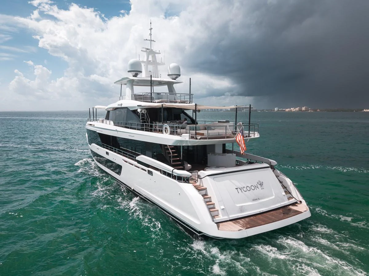 A luxurious yacht cruises through the open sea under a dramatic sky. aboard TYCOON Yacht for Sale