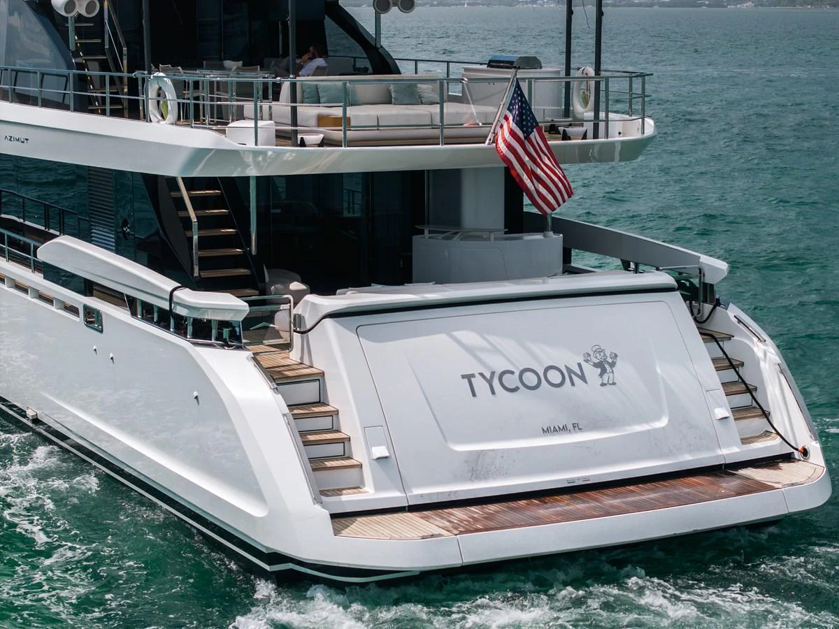 The yacht's aft deck features a spacious swim platform and elegant design, perfect for enjoying the water. aboard TYCOON Yacht for Sale