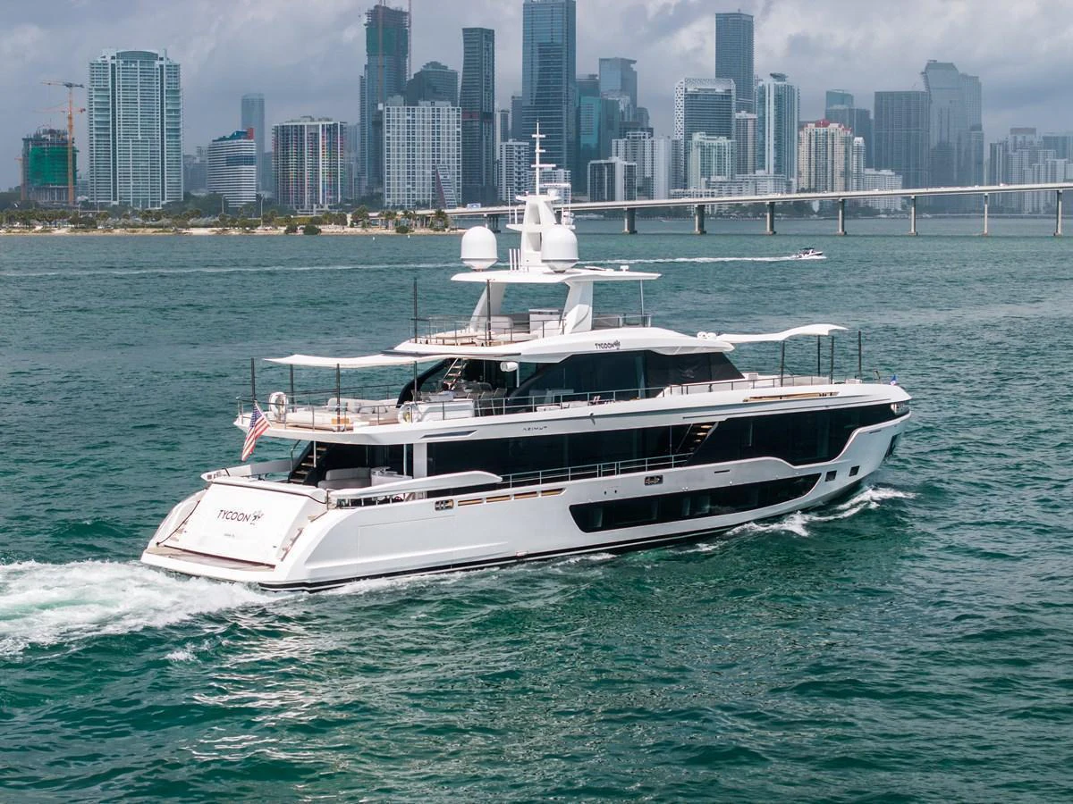 A sleek and modern yacht cruising in front of a vibrant city skyline. aboard TYCOON Yacht for Sale