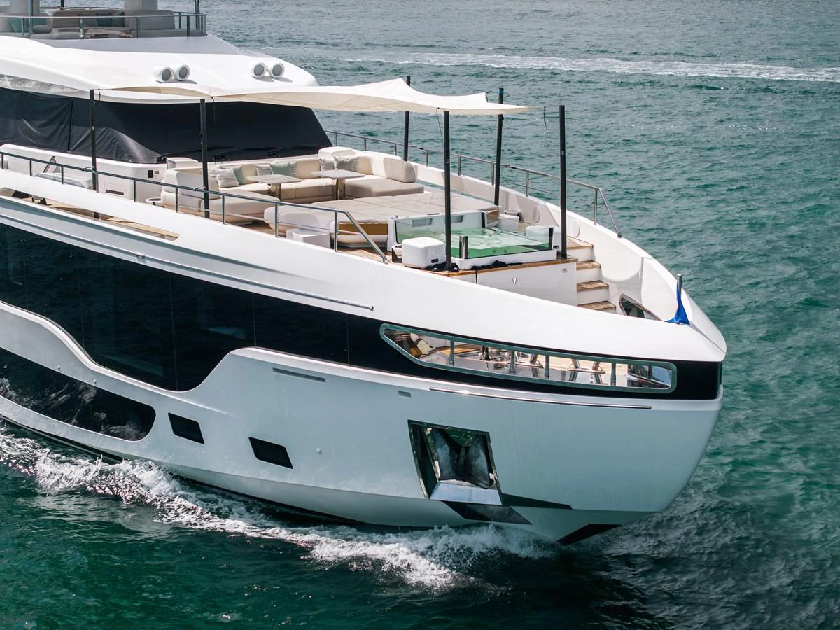 A sleek and modern yacht cruising on the water with ample seating on the deck. aboard TYCOON Yacht for Sale