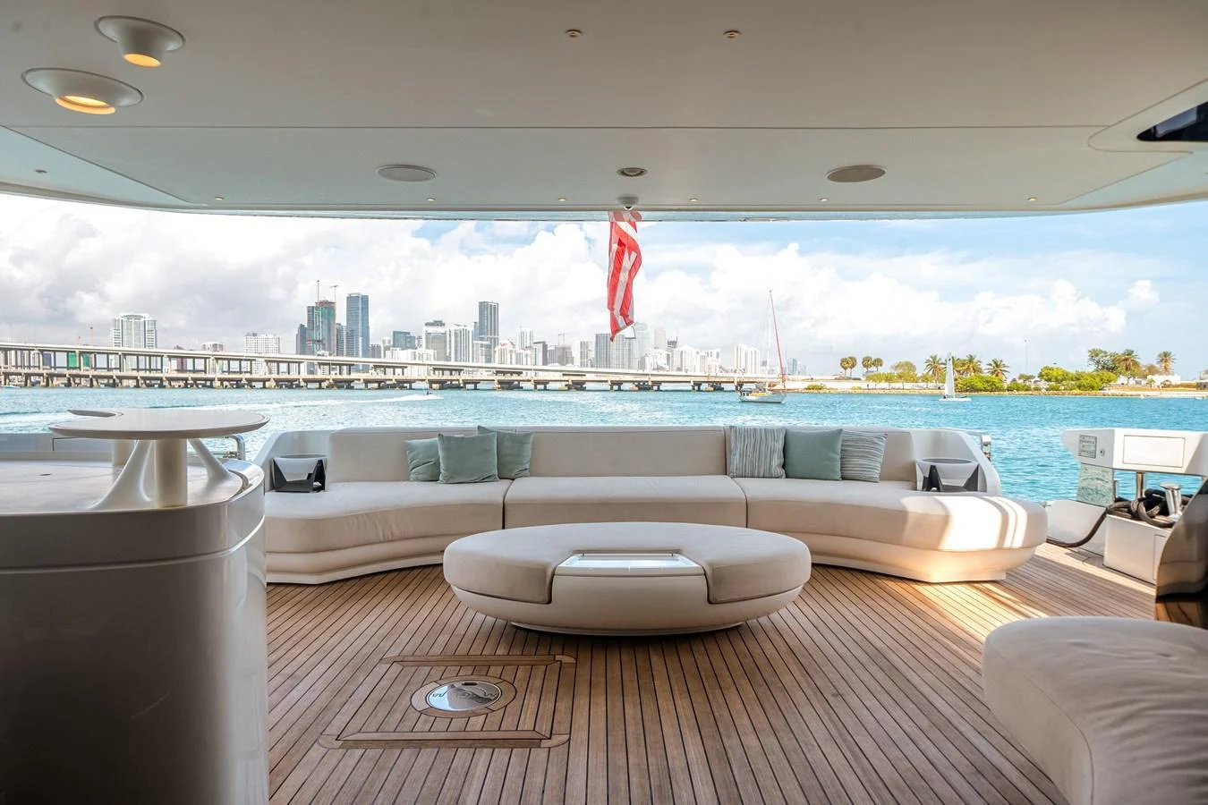 The aft deck features a spacious seating area with a stunning view of the city skyline and ocean. aboard TYCOON Yacht for Sale