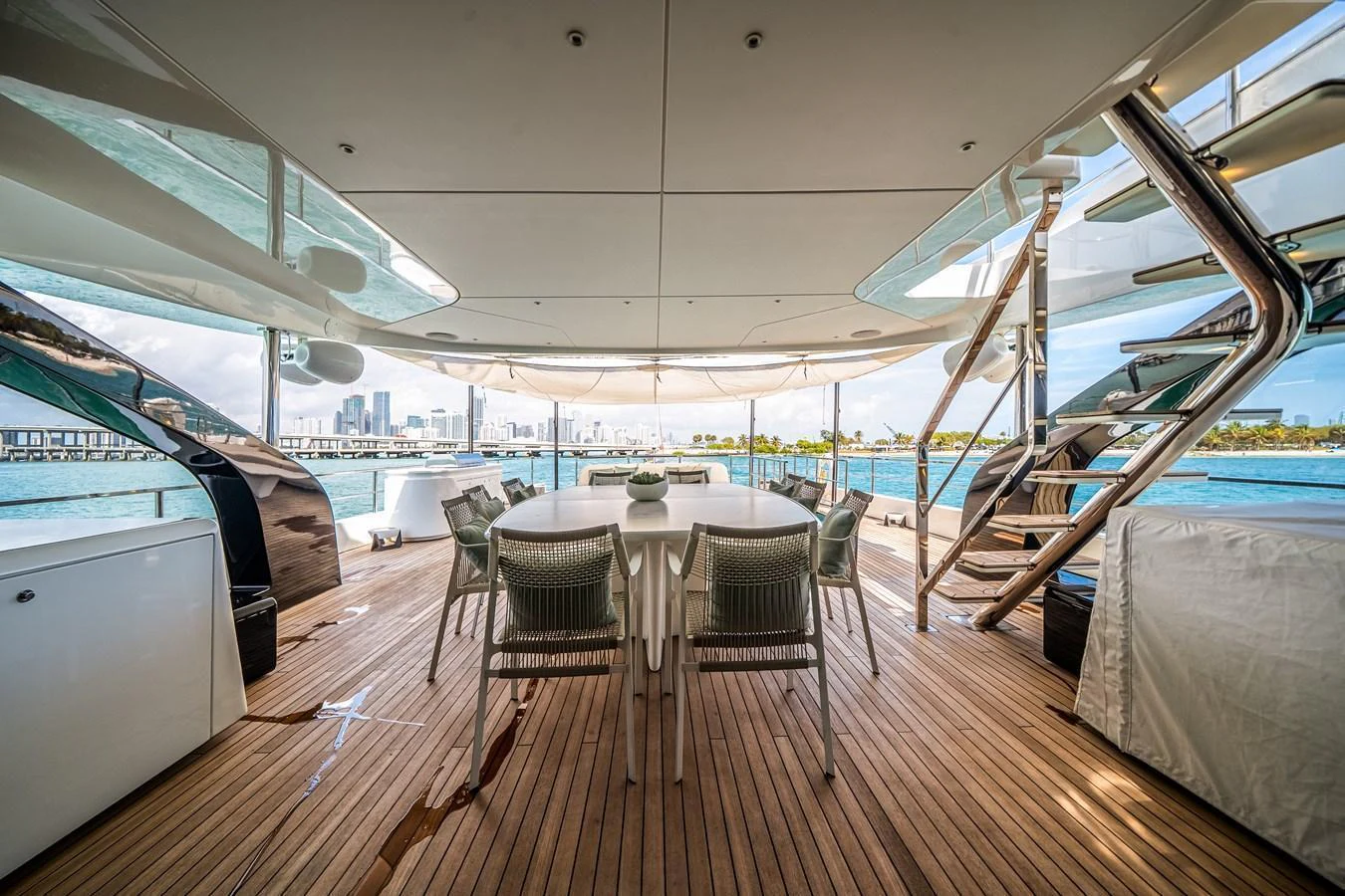 The aft deck offers a spacious and elegant outdoor dining area with stunning views of the water. aboard TYCOON Yacht for Sale