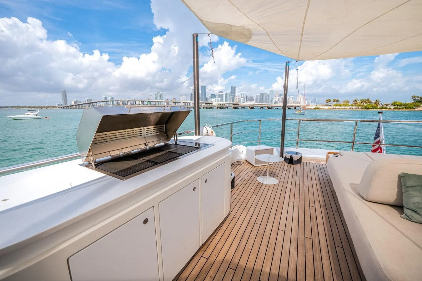 The aft deck features a spacious lounging area with a grill, perfect for outdoor dining and relaxation. aboard TYCOON Yacht for Sale