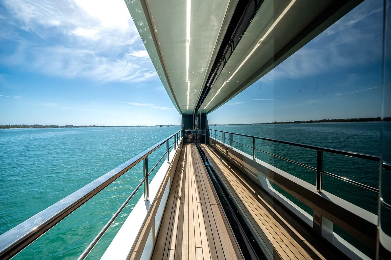 The sleek side deck offers stunning views of the surrounding waters. aboard TYCOON Yacht for Sale