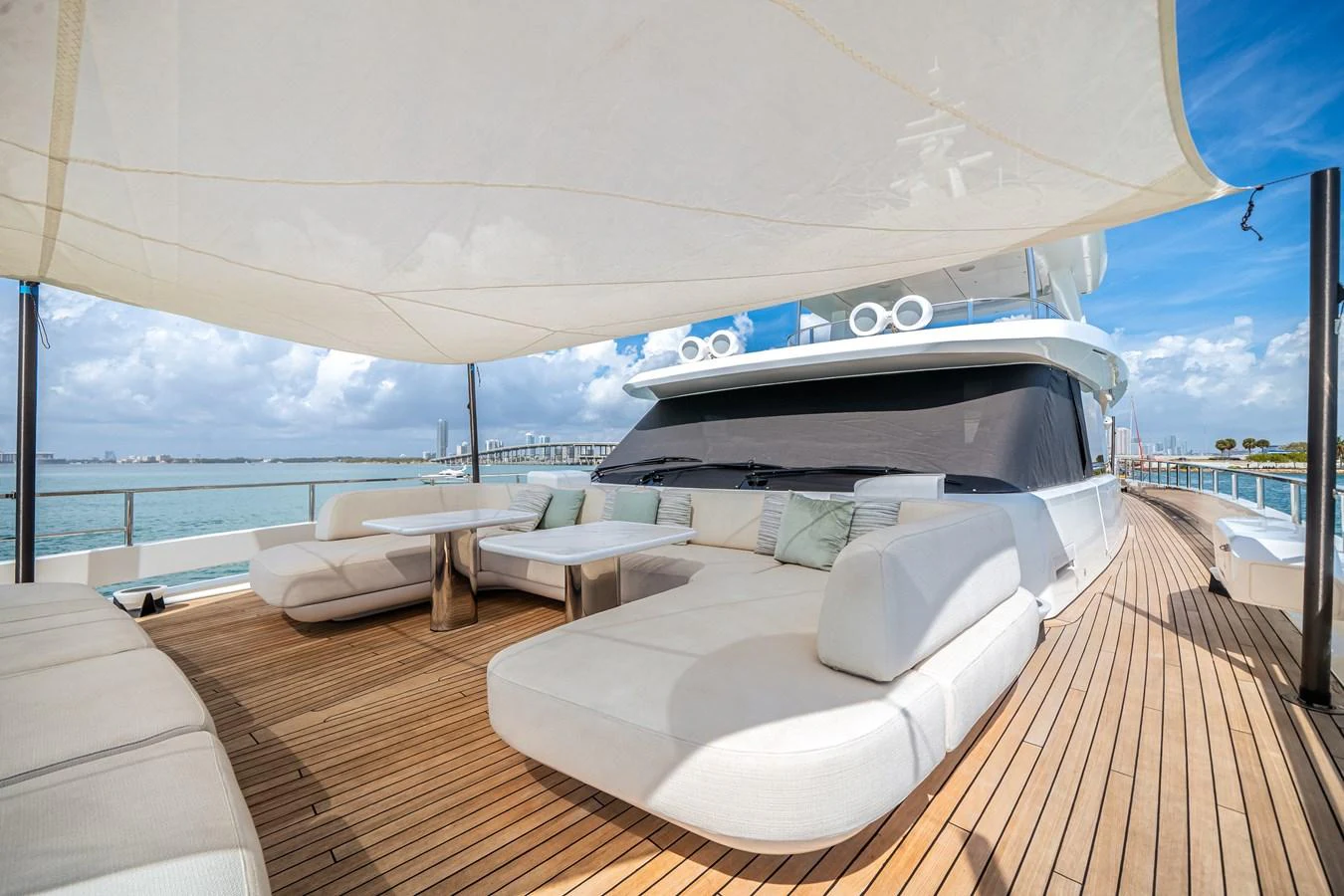 The aft deck features luxurious seating and a shaded area, perfect for relaxation and socializing. aboard TYCOON Yacht for Sale