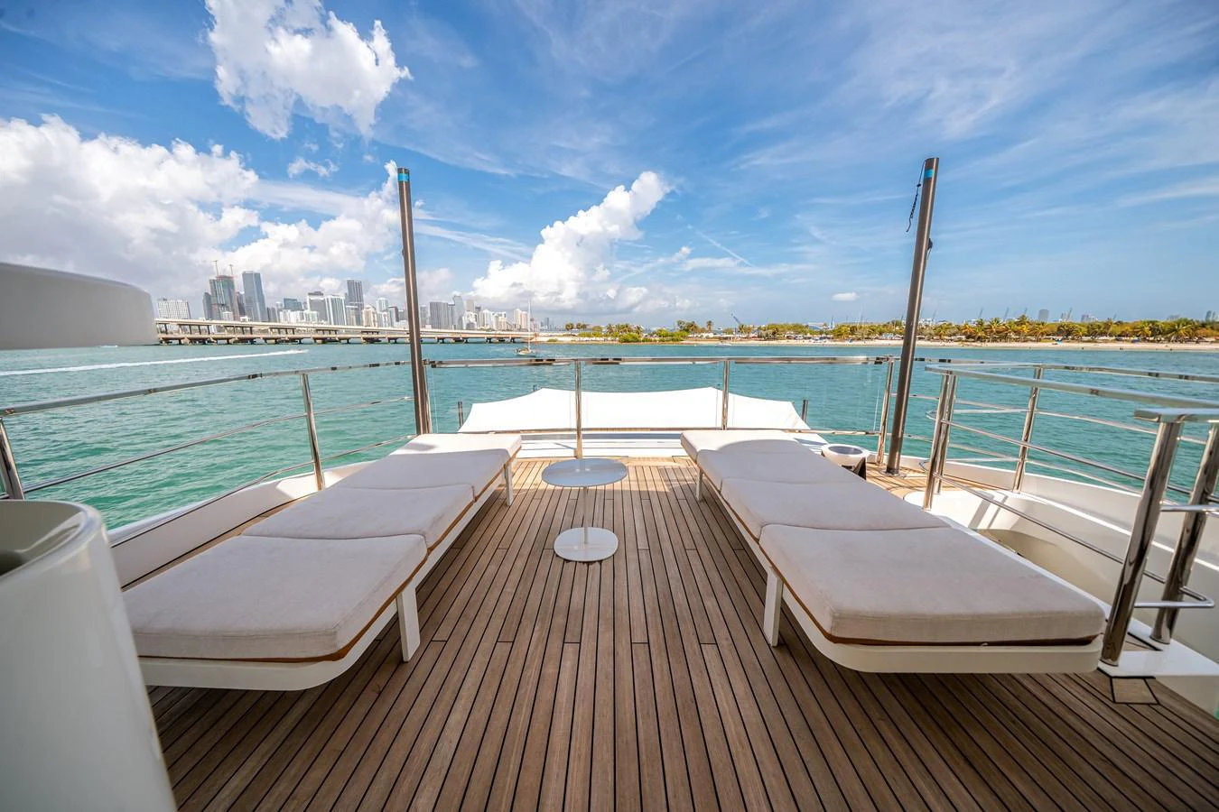 The sundeck offers a serene space with plush loungers and stunning views of the water and city skyline. aboard TYCOON Yacht for Sale