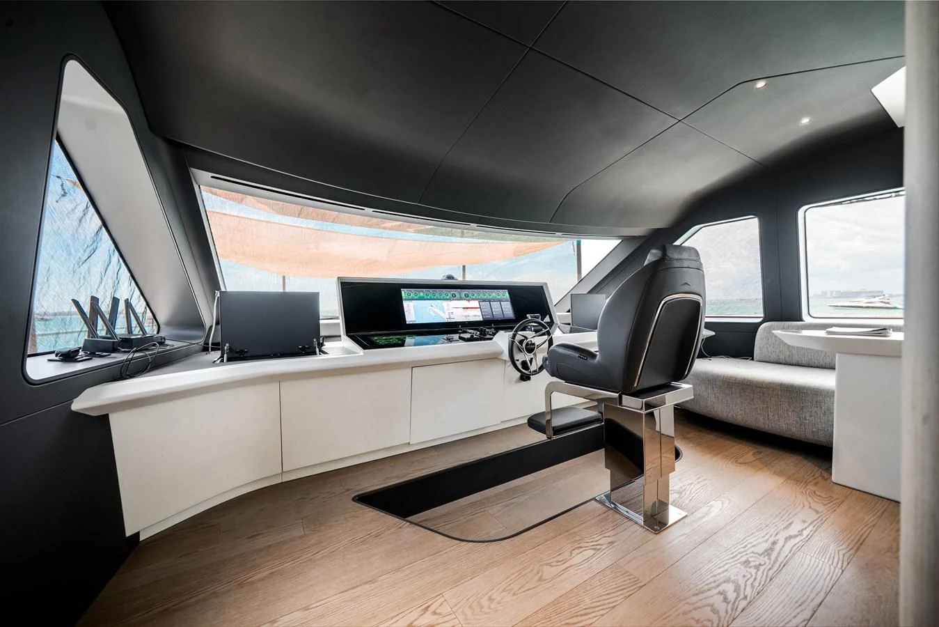 The helm station features modern controls and a sleek design with panoramic views. aboard TYCOON Yacht for Sale