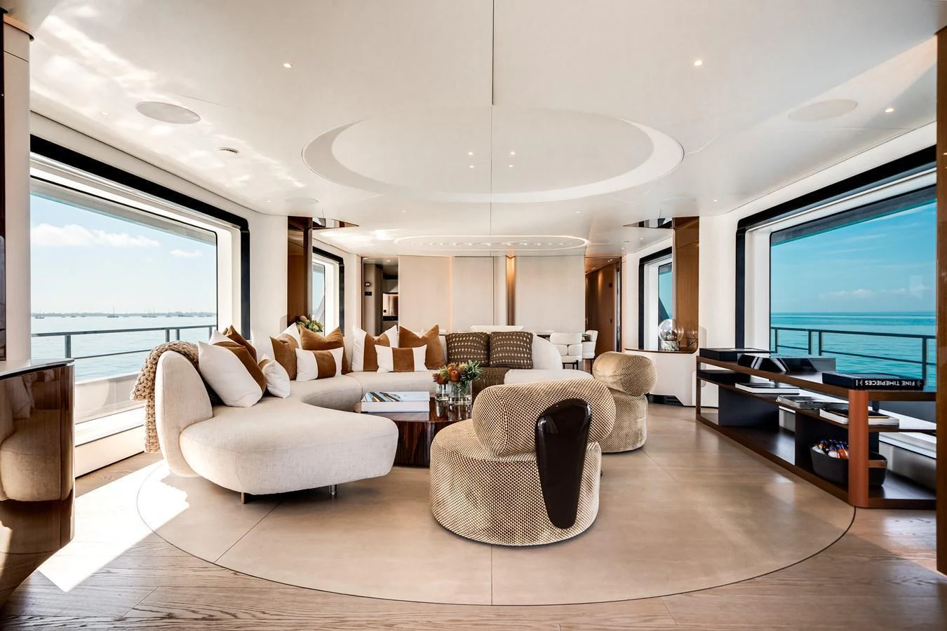 The salon features luxurious seating with panoramic ocean views through large windows. aboard TYCOON Yacht for Sale