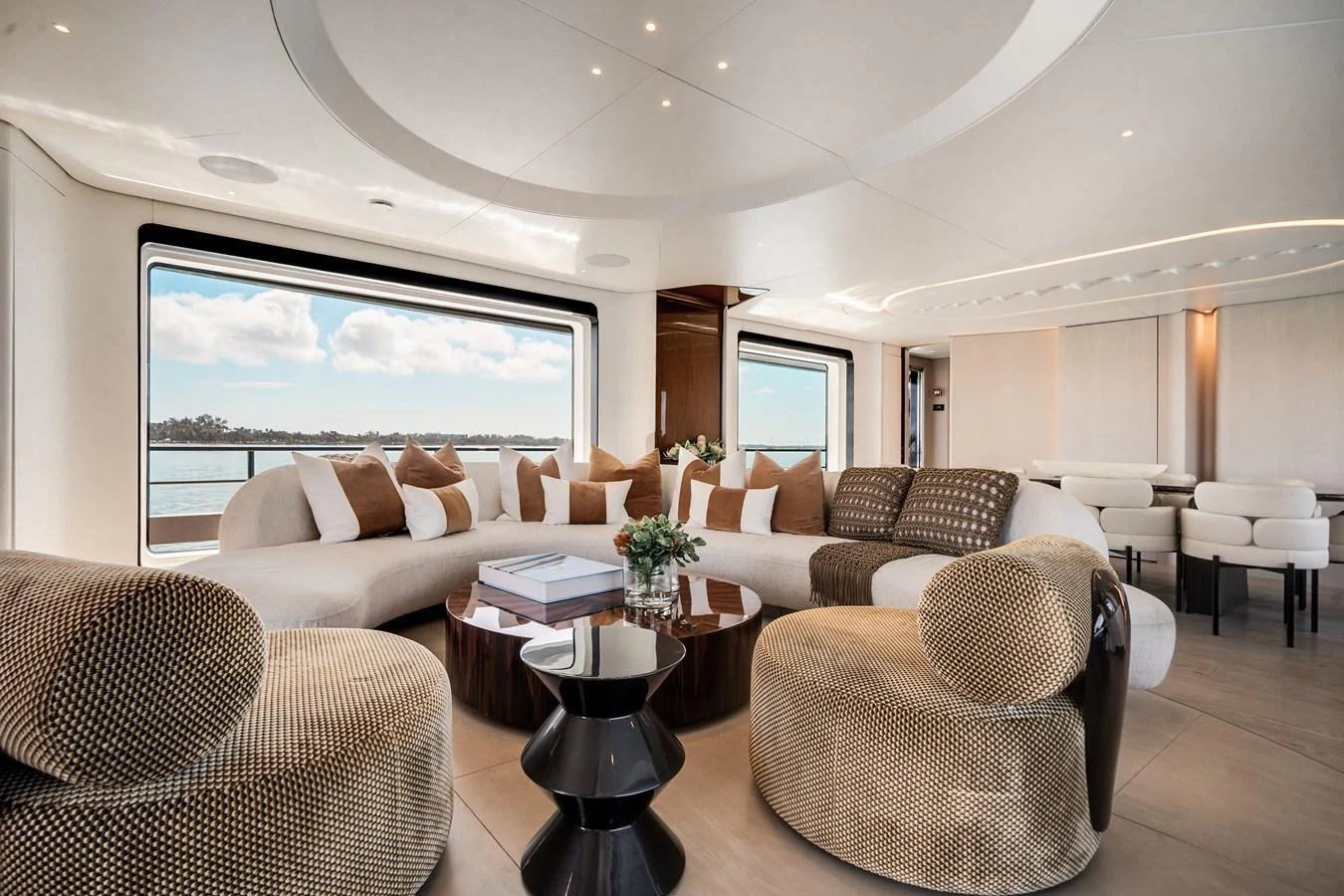 The yacht's salon features a spacious and elegantly designed seating area with large windows offering stunning views. aboard TYCOON Yacht for Sale