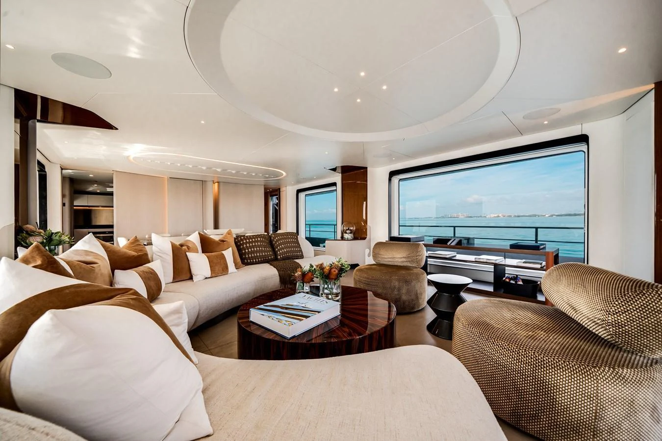 The salon features luxurious seating with panoramic ocean views. aboard TYCOON Yacht for Sale