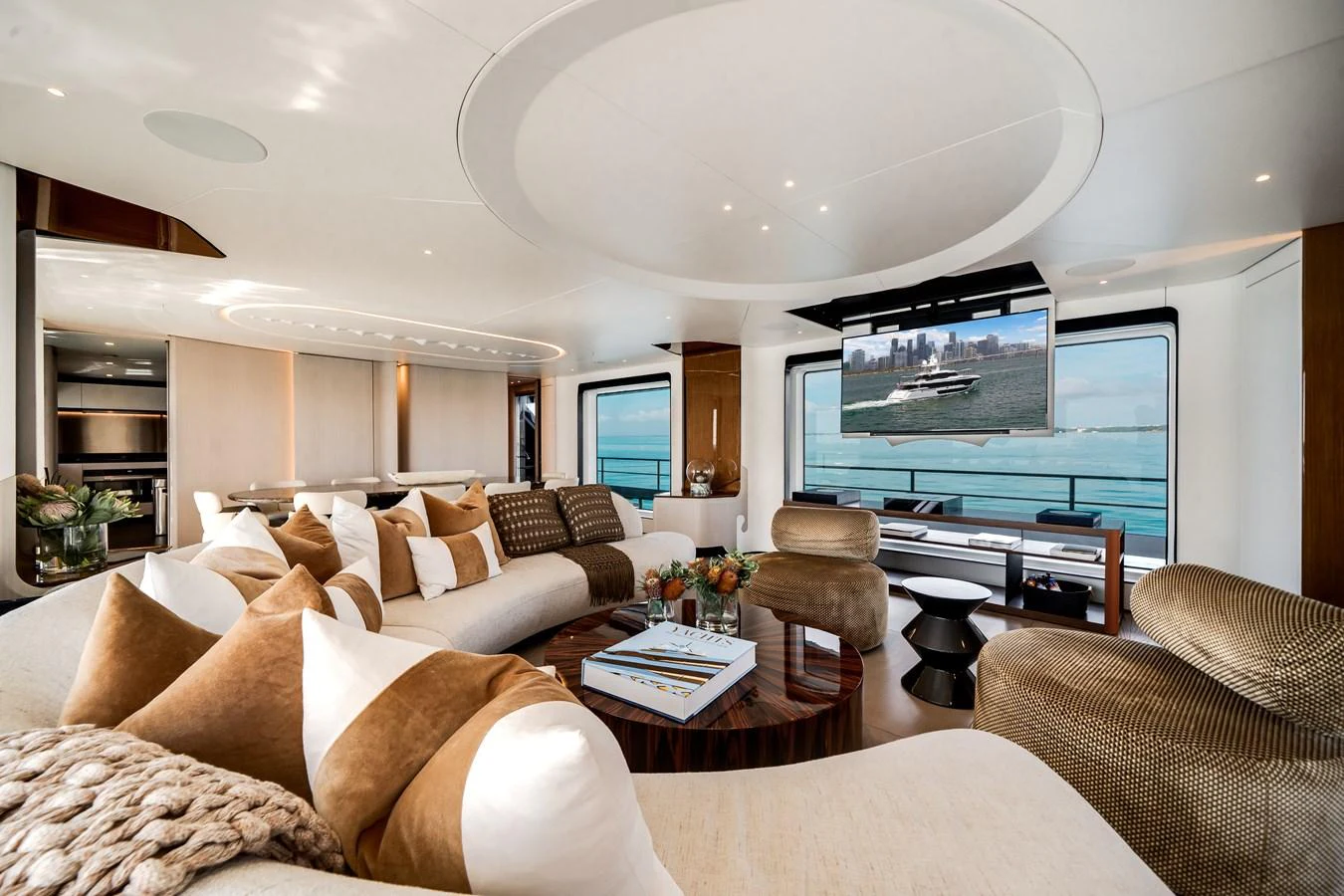 The salon features luxurious seating with panoramic windows offering stunning ocean views. aboard TYCOON Yacht for Sale