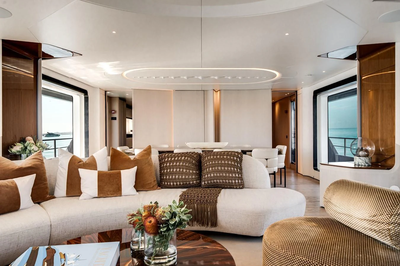 The salon features a luxurious and spacious seating area with elegant decor and large windows offering stunning views. aboard TYCOON Yacht for Sale