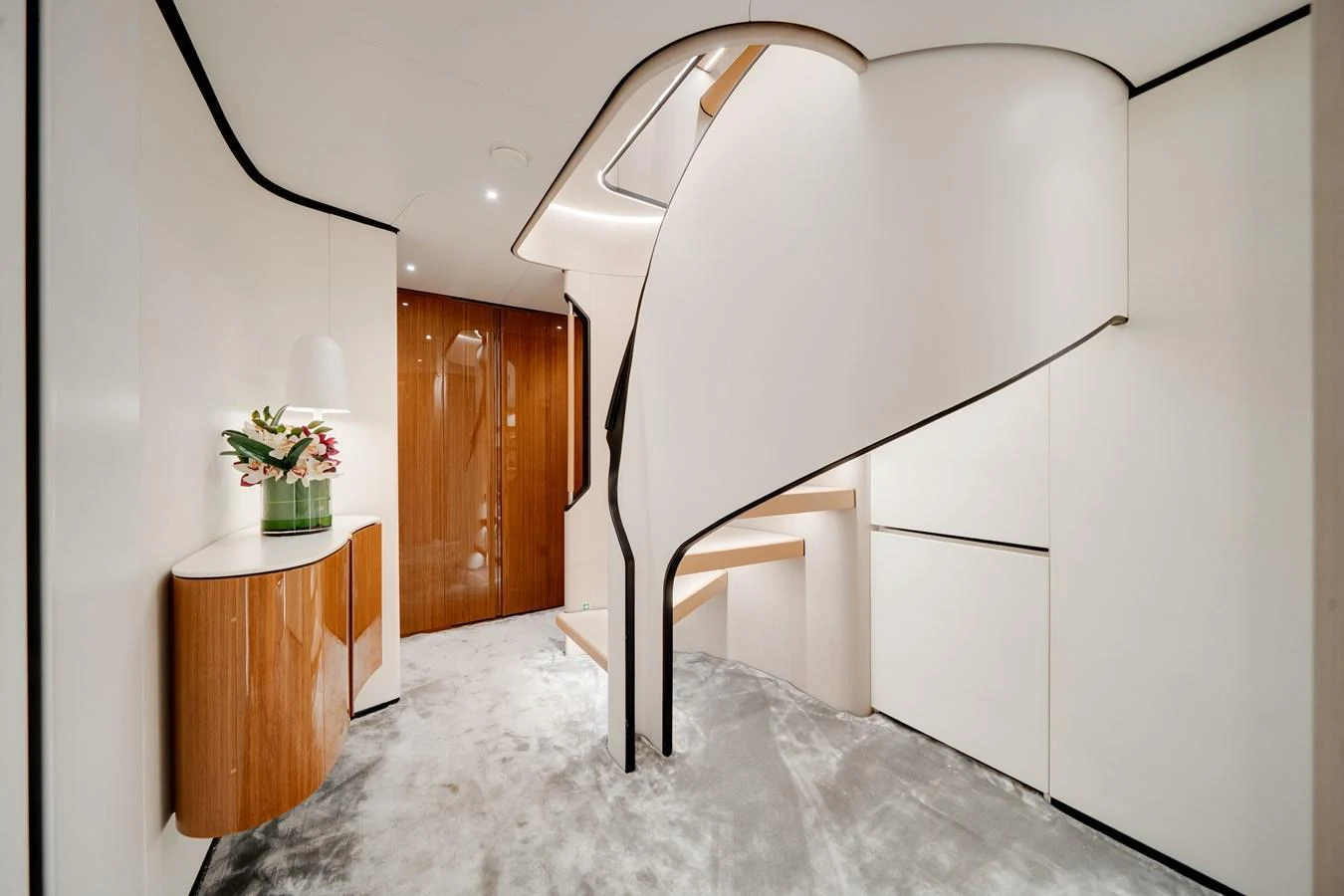 A modern and elegant staircase with sleek design elements and luxurious finishes. aboard TYCOON Yacht for Sale