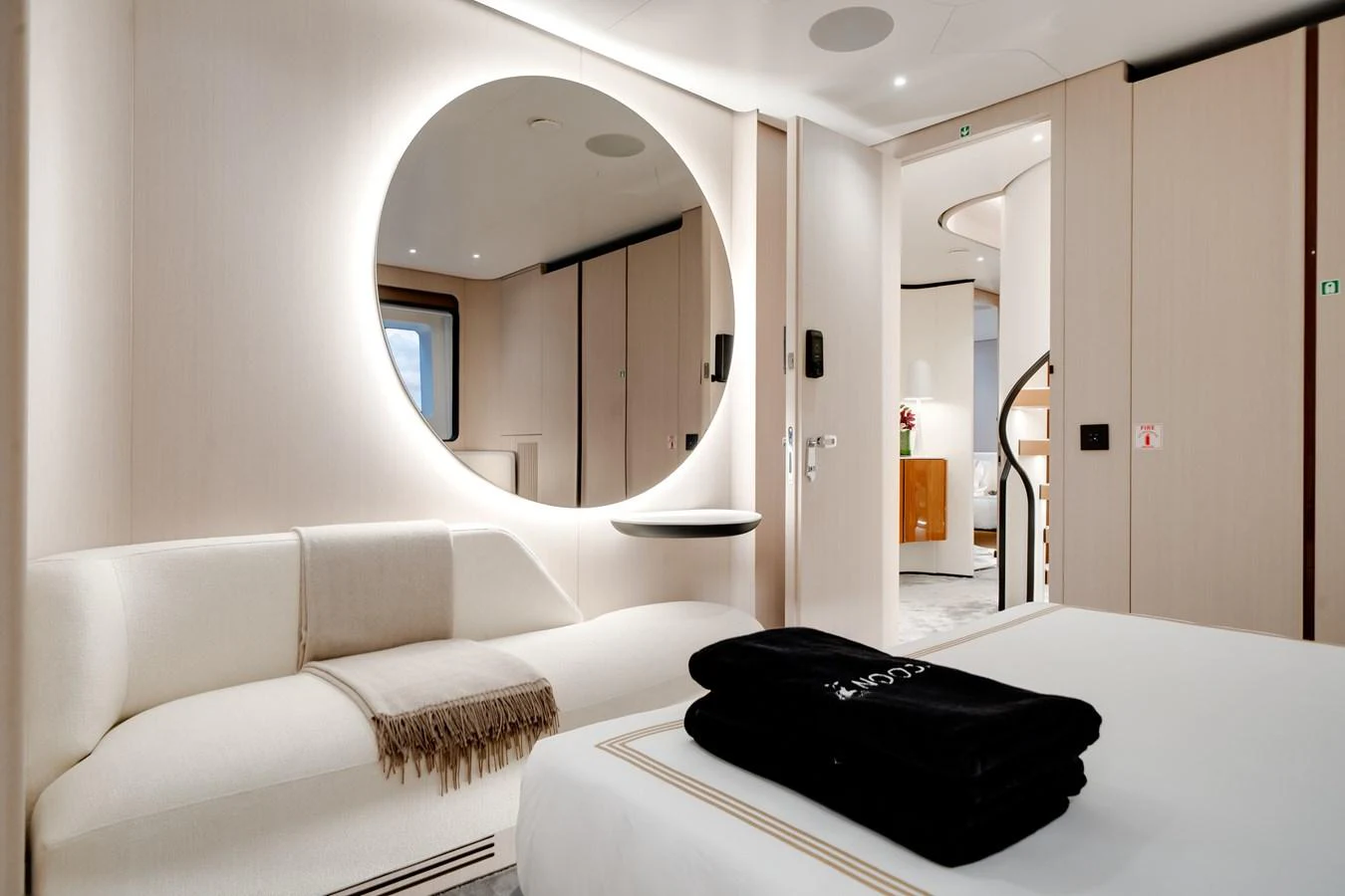 The stateroom features a modern design with a cozy seating area and elegant lighting. aboard TYCOON Yacht for Sale
