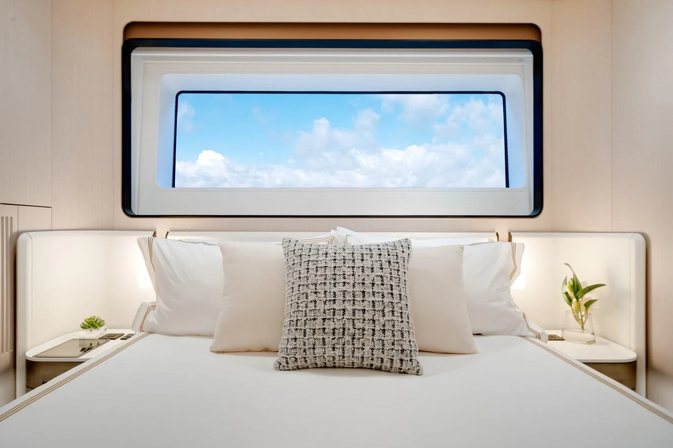 A serene stateroom with a large window offering a view of the sky. aboard TYCOON Yacht for Sale