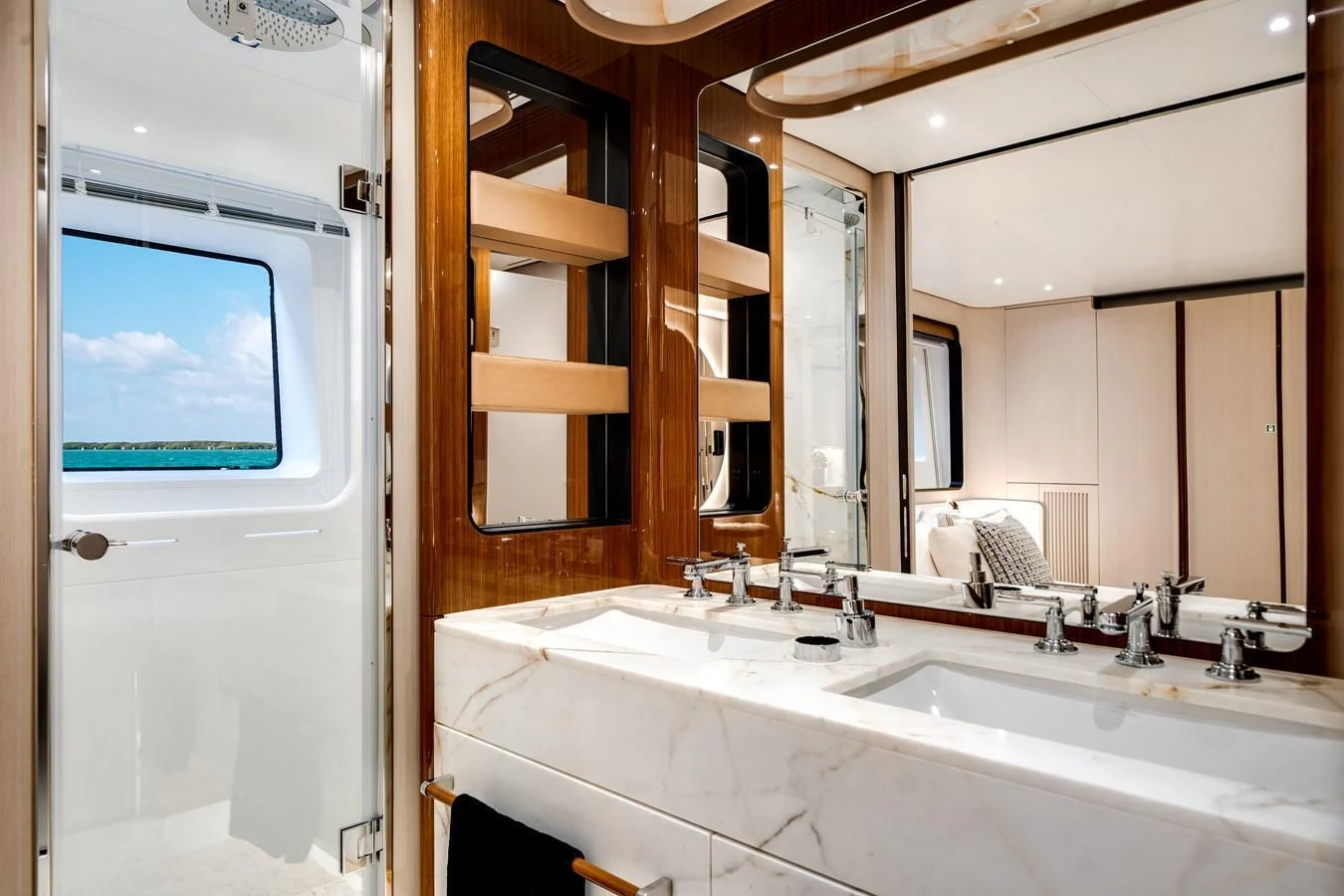 This luxurious yacht bathroom features a double sink vanity with a large mirror and elegant fixtures. aboard TYCOON Yacht for Sale