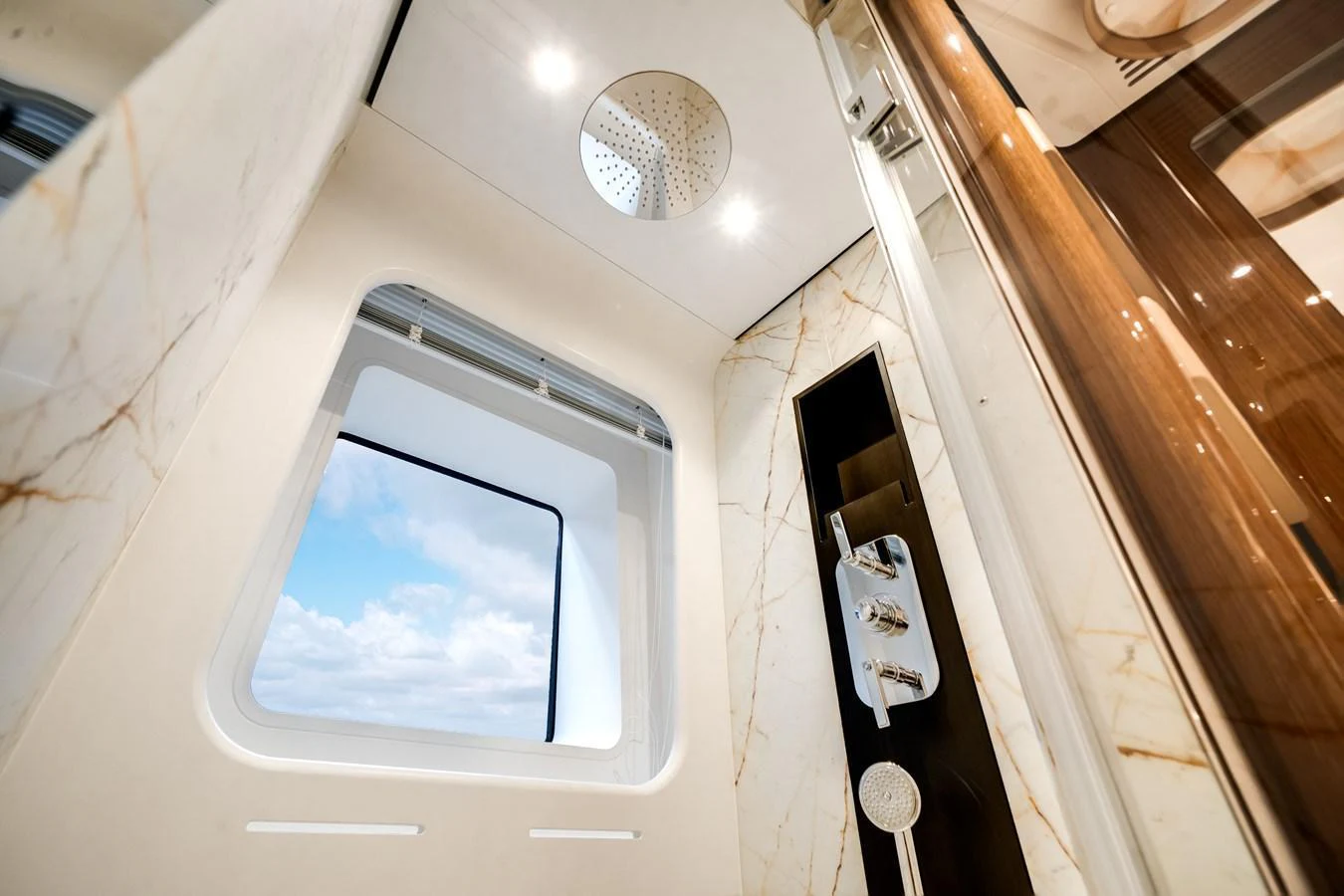 A luxurious yacht bathroom with a large window and modern fixtures. aboard TYCOON Yacht for Sale