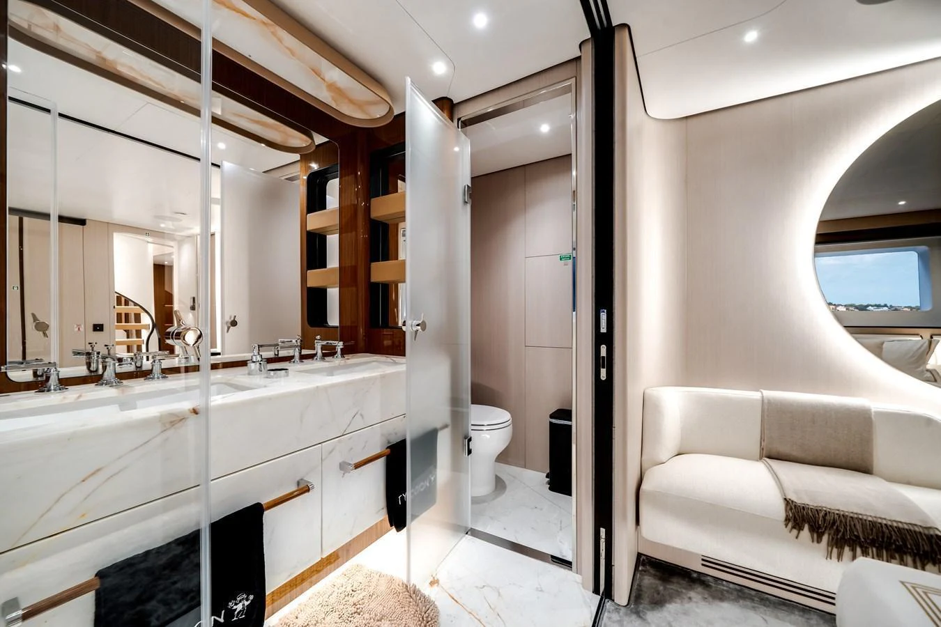 The yacht's bathroom features luxurious fixtures and a modern design, complemented by a cozy seating area. aboard TYCOON Yacht for Sale