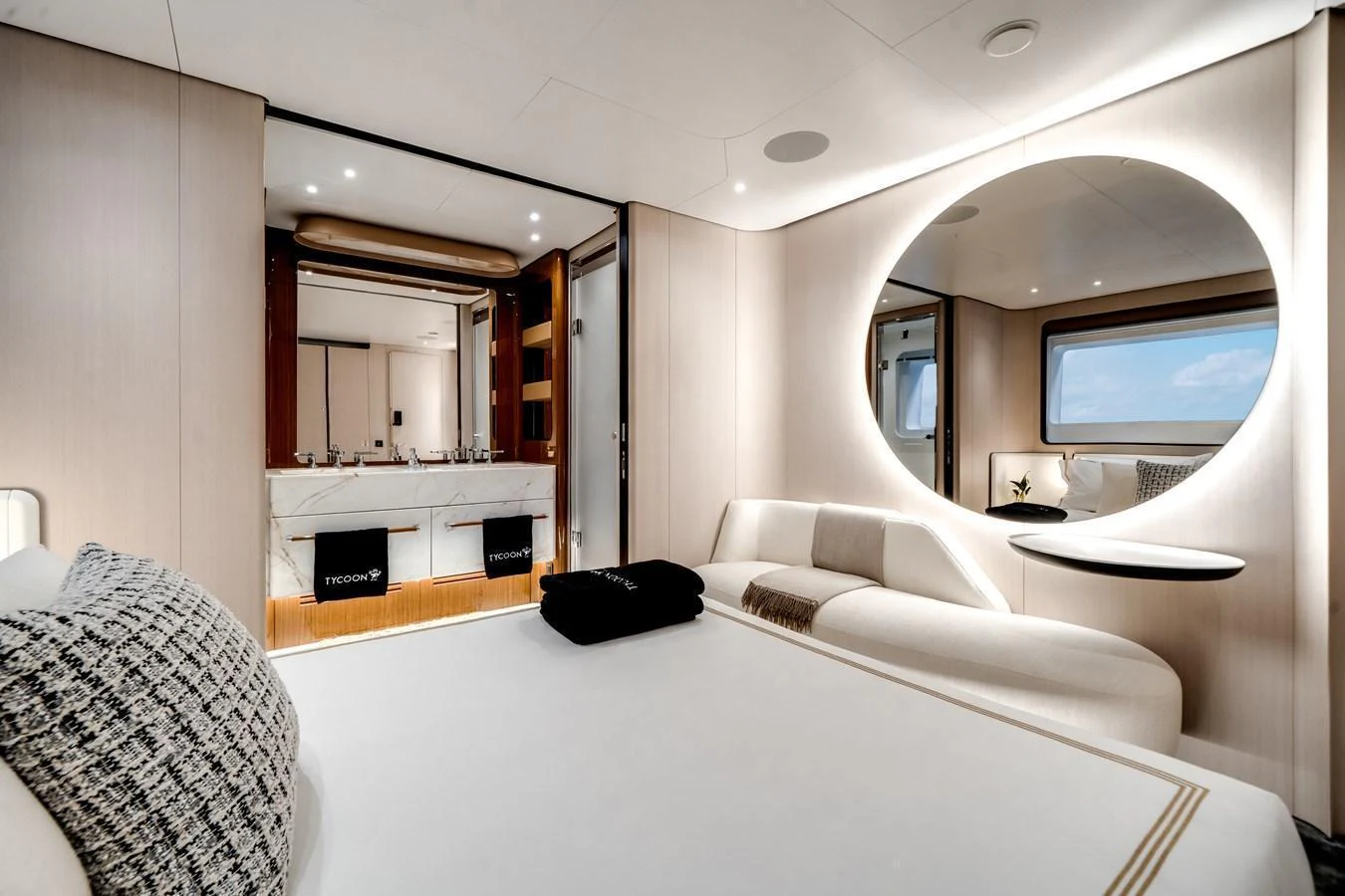The stateroom features a luxurious bed, modern furnishings, and a stylish ensuite bathroom. aboard TYCOON Yacht for Sale