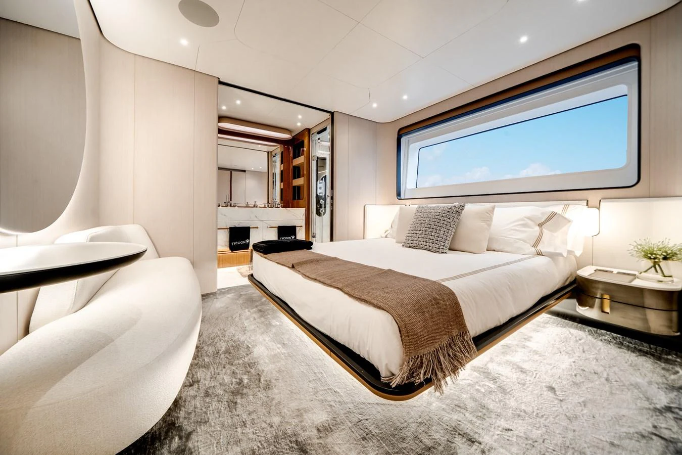 The master stateroom offers a luxurious and serene retreat with a large bed, elegant decor, and ample natural light. aboard TYCOON Yacht for Sale