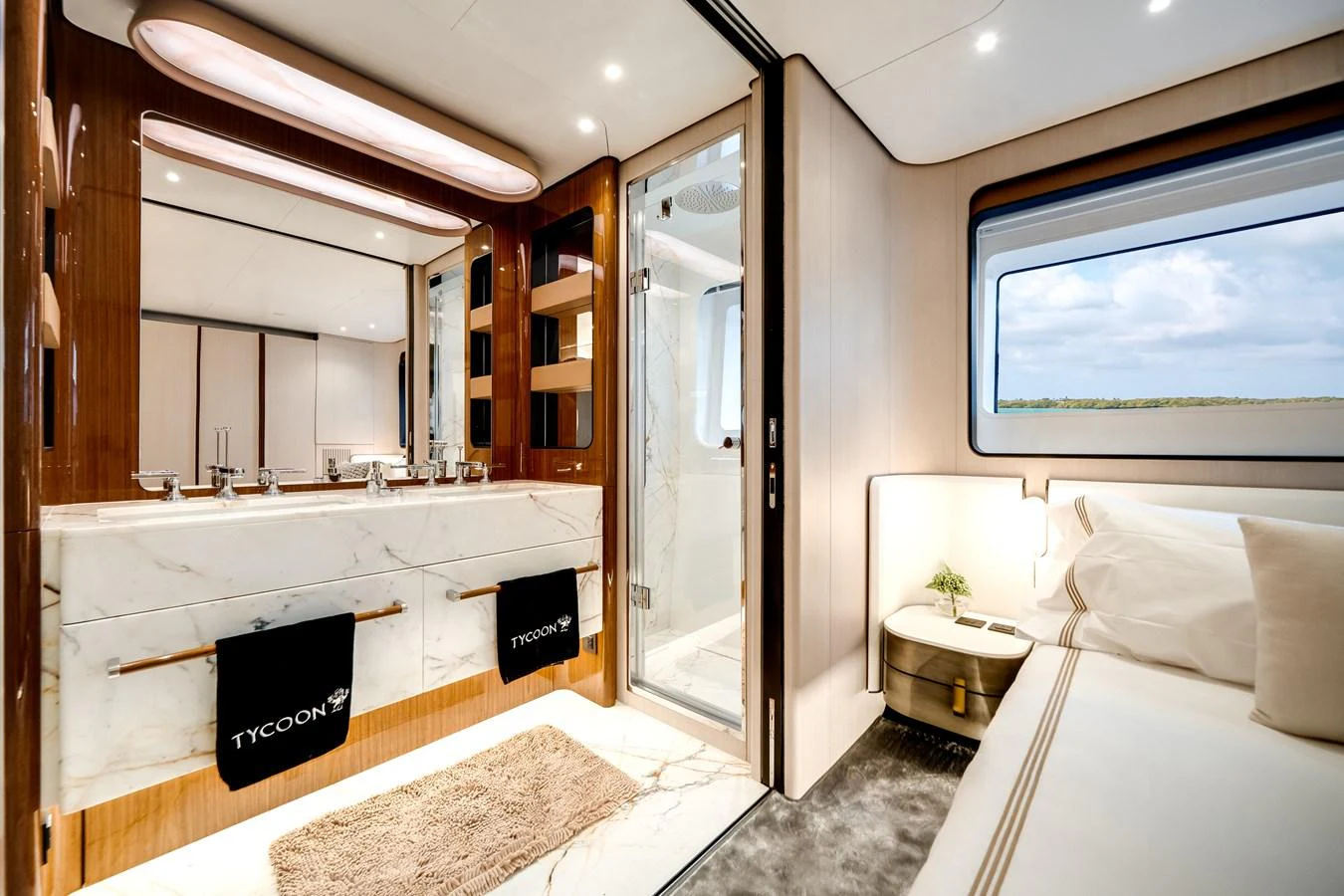 The master stateroom features a luxurious ensuite bathroom with elegant marble finishes and a spacious sleeping area with a large window offering scenic views. aboard TYCOON Yacht for Sale