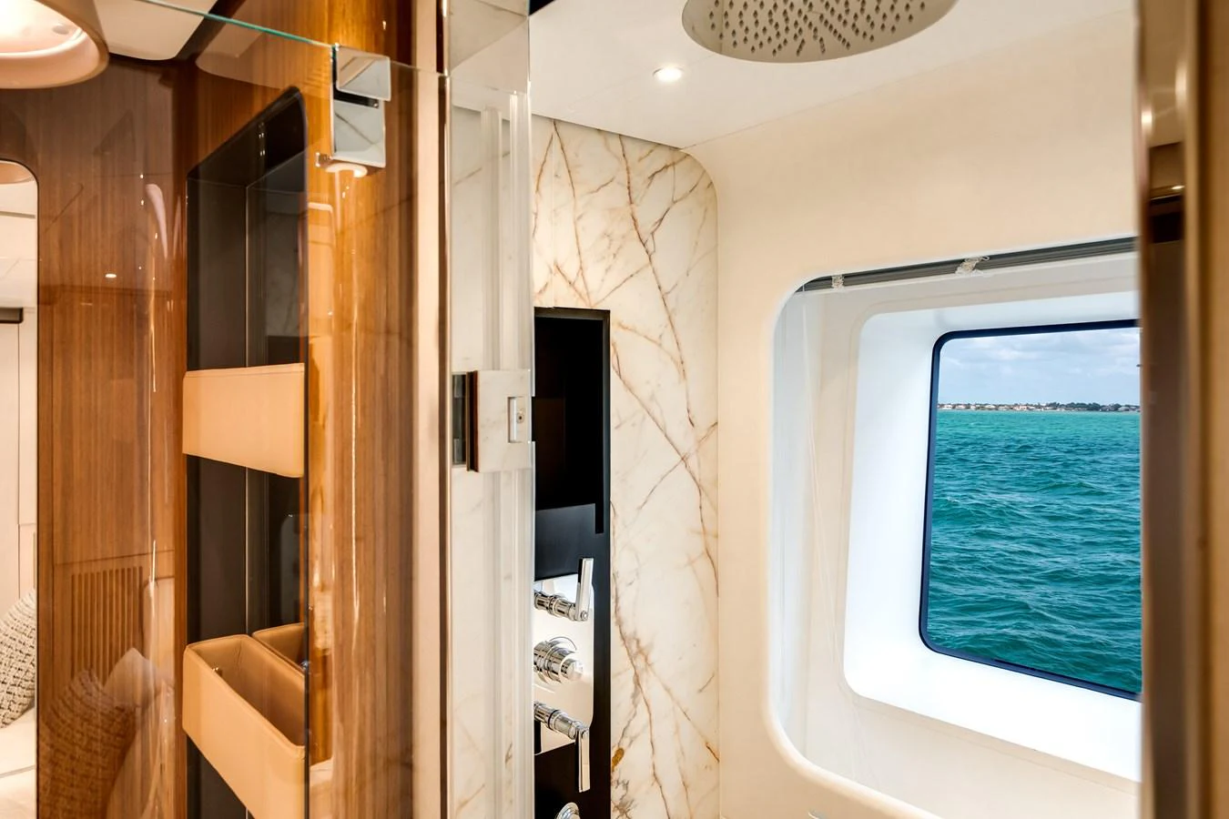 A luxurious yacht interior featuring a large window with a stunning ocean view. aboard TYCOON Yacht for Sale