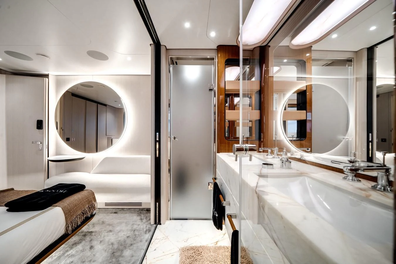 The yacht's bathroom features modern fixtures, a large mirror, and elegant lighting. aboard TYCOON Yacht for Sale