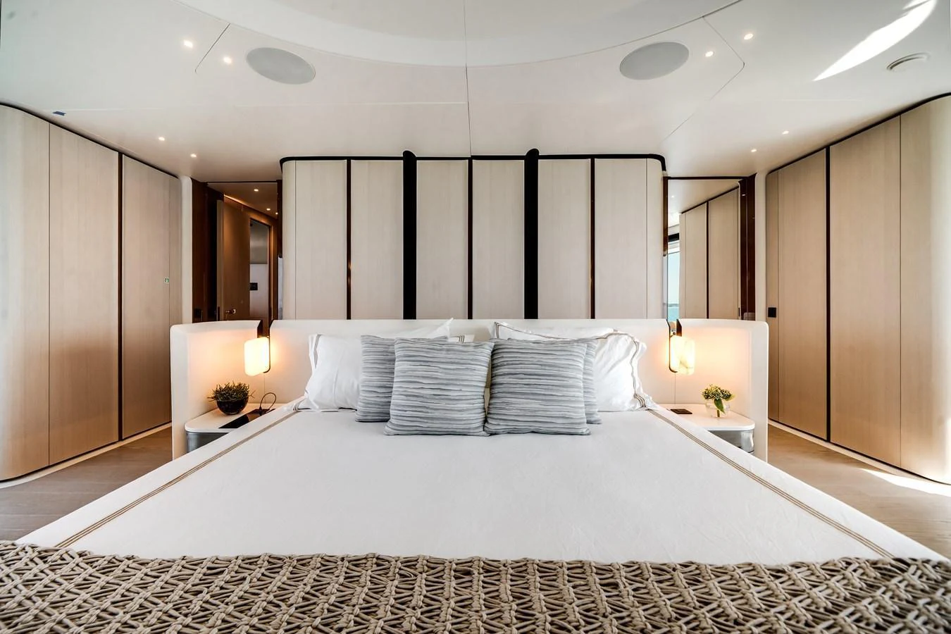 The master stateroom features a spacious bed with elegant lighting and modern decor. aboard TYCOON Yacht for Sale