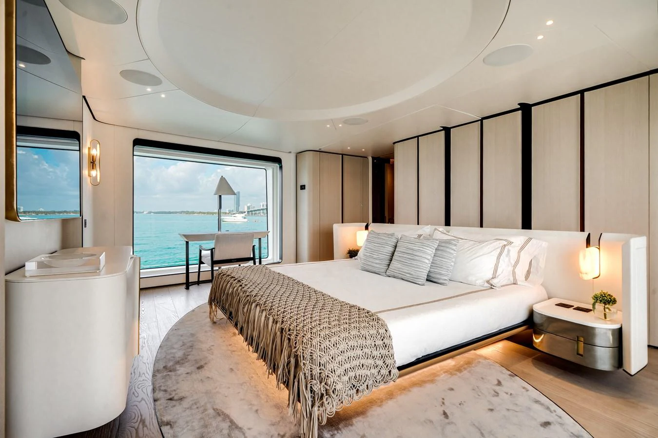 The master stateroom features a luxurious bed with a stunning view of the ocean through large windows. aboard TYCOON Yacht for Sale
